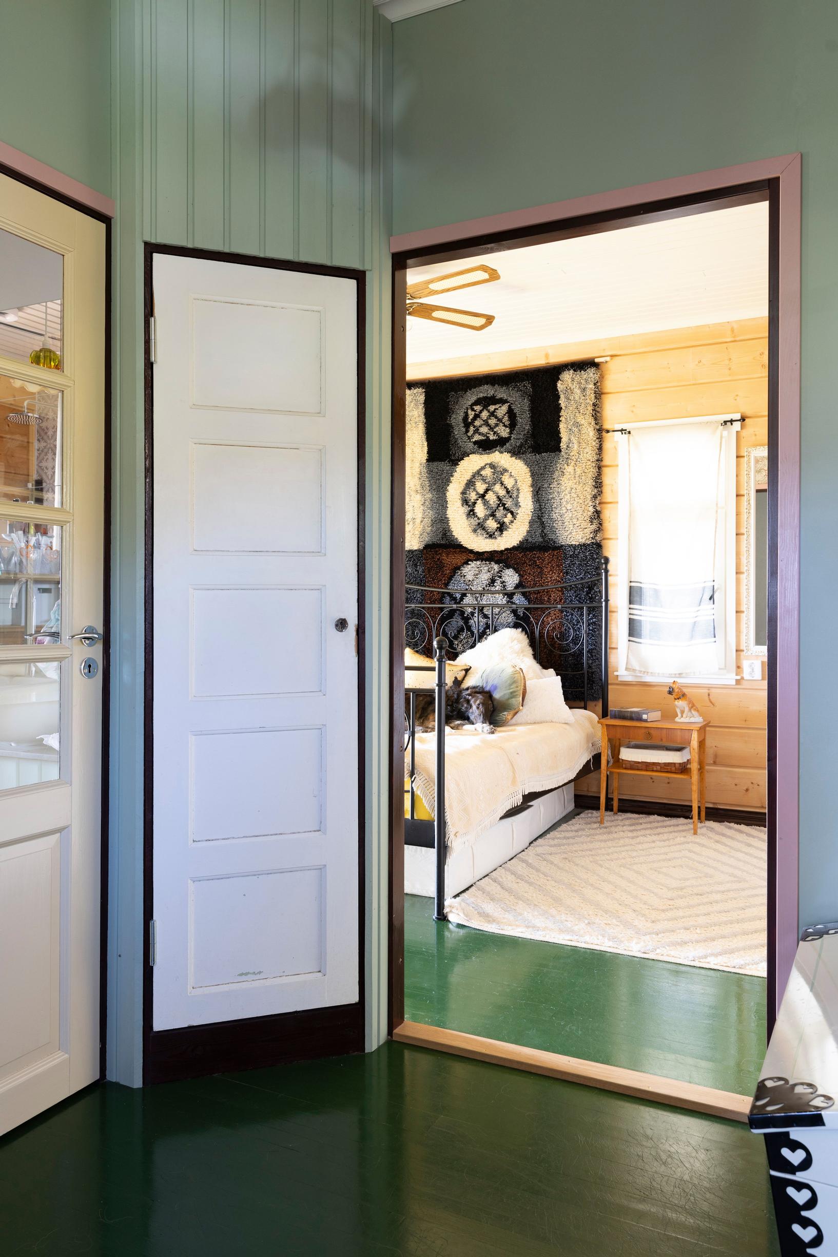 A bedroom doorway. Green walls and a green floor.