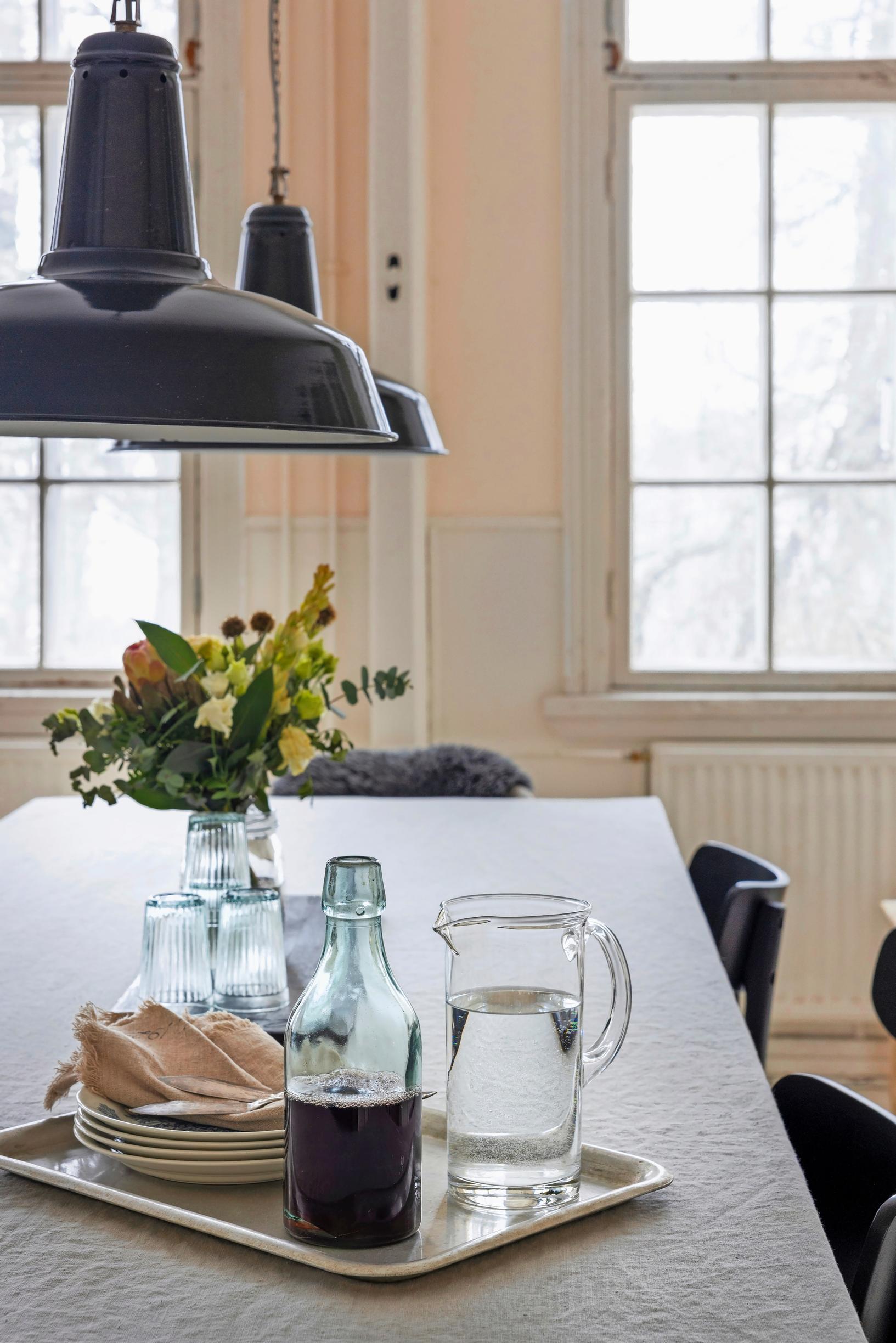 A dining table set with a linen tablecloth
