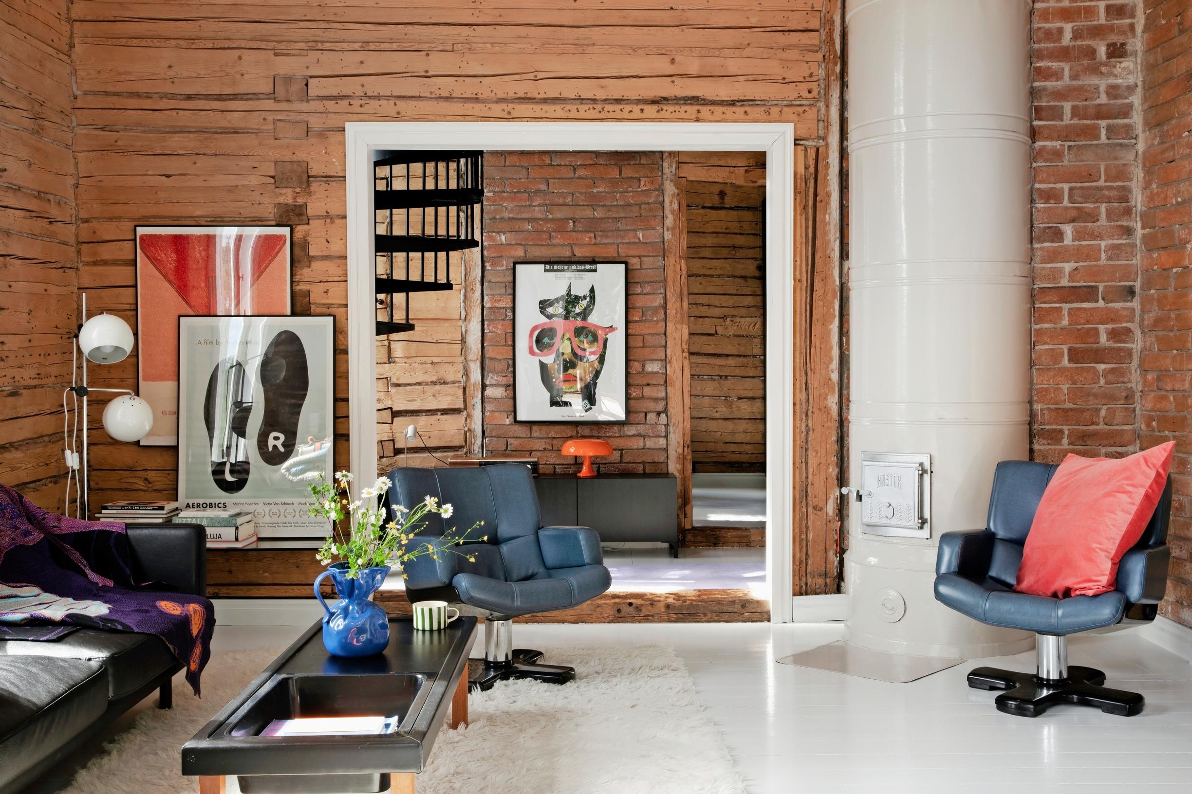A living room with exposed log walls.