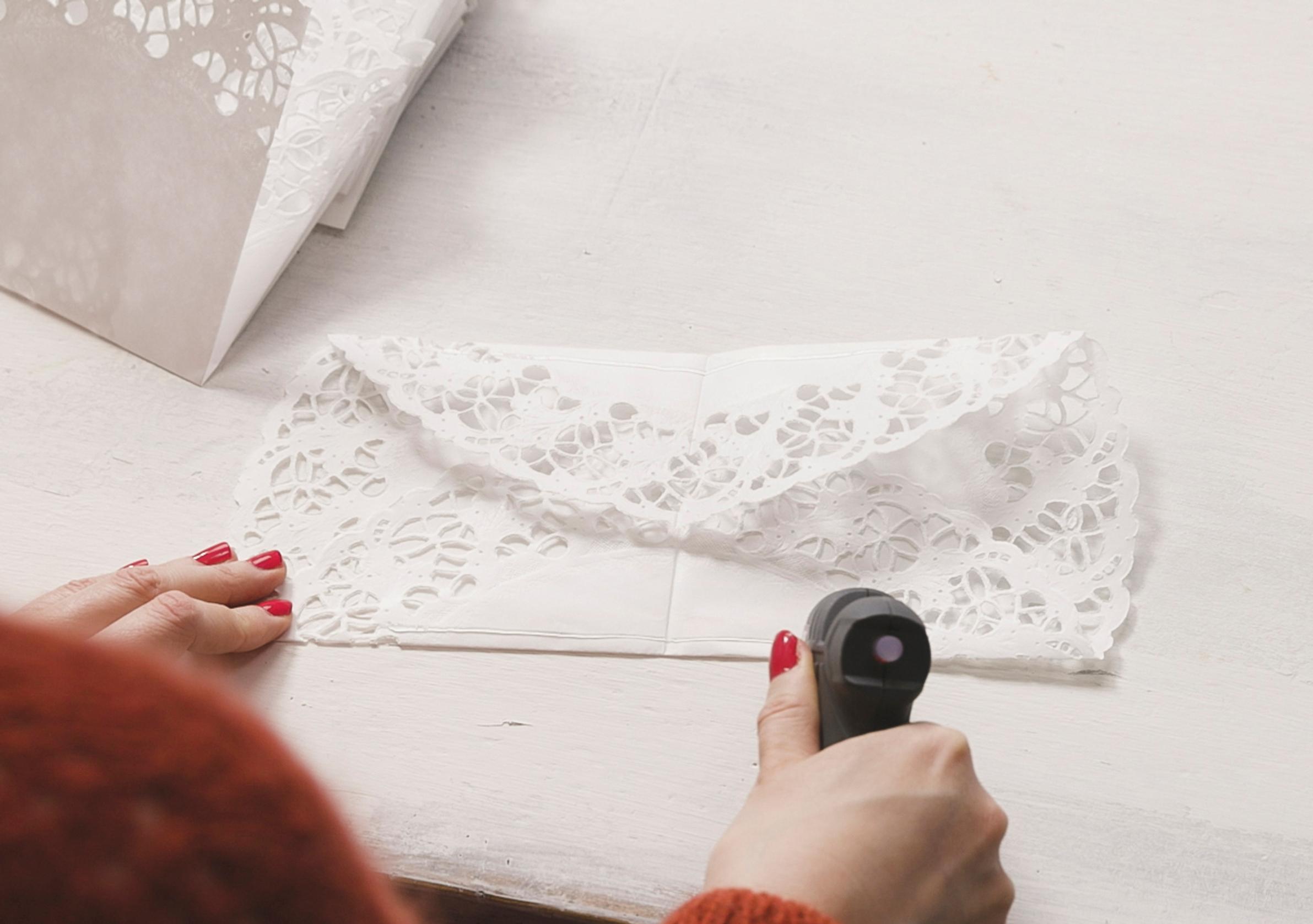 Gluing the sides of the paper doily