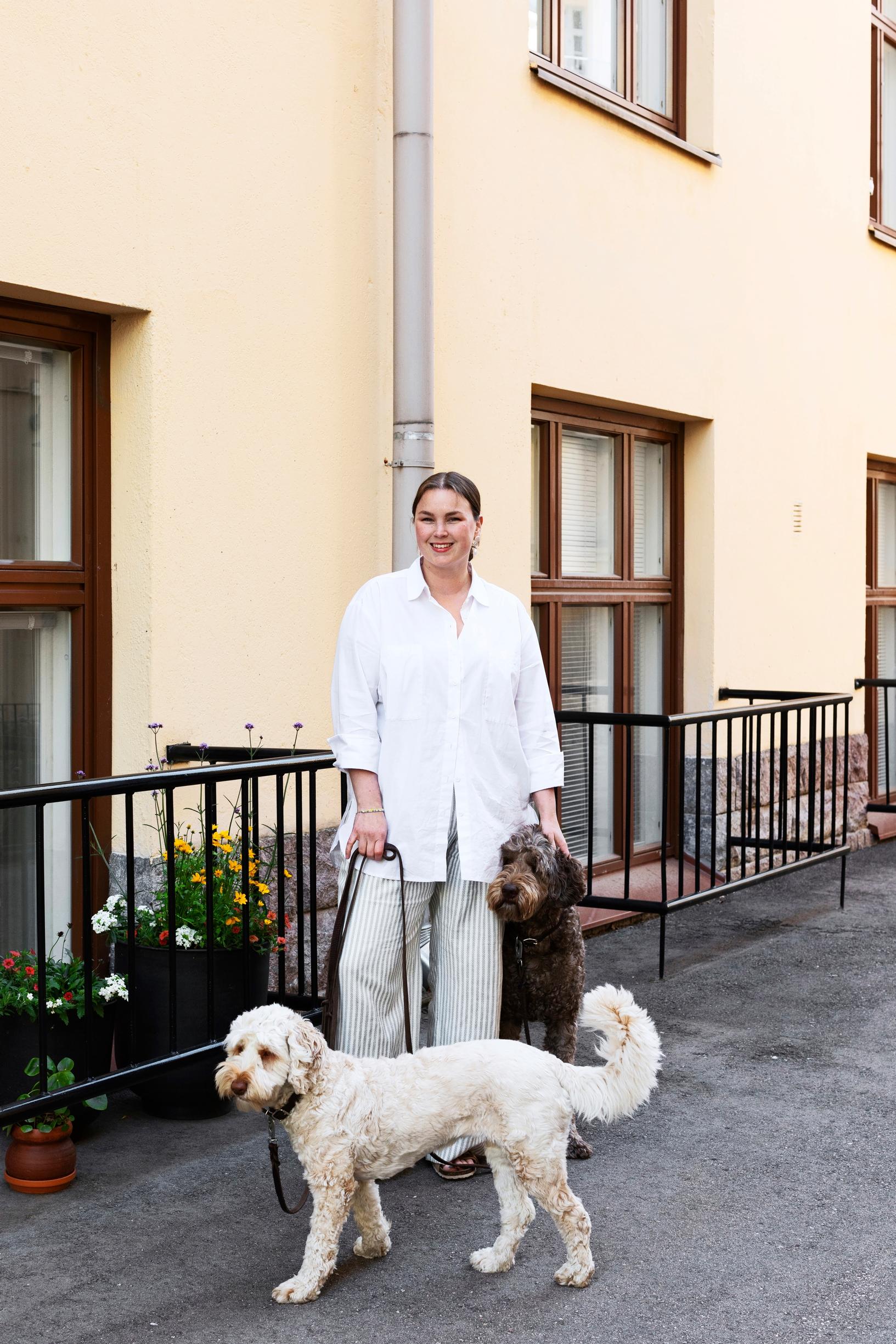 Stylist Annika Huurrekorpi and her Australian Labradoodles in front of the living room window
