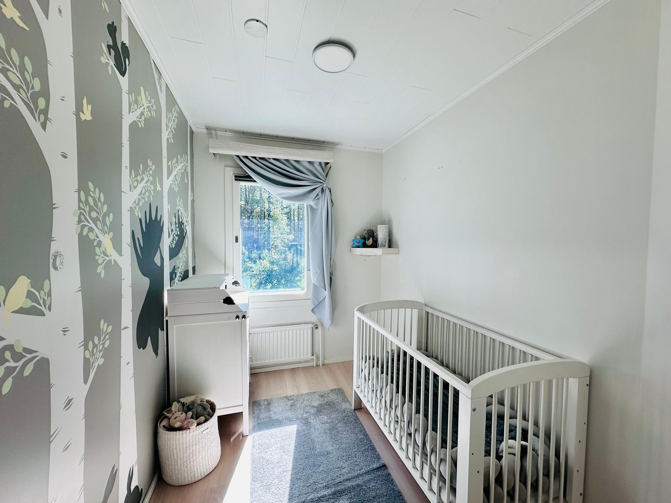The crib fits against the left-side wall, and there’s room for a changing table on the right.
