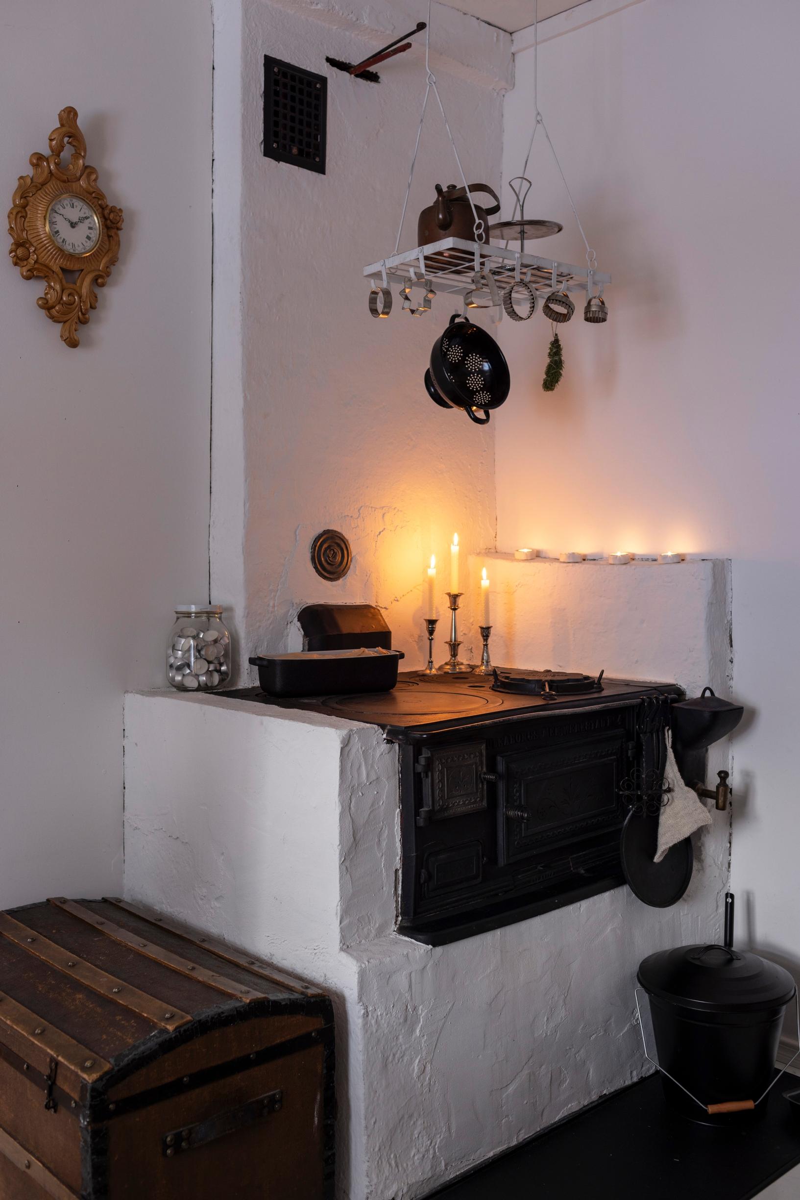 A wood-burning stove with candles on top