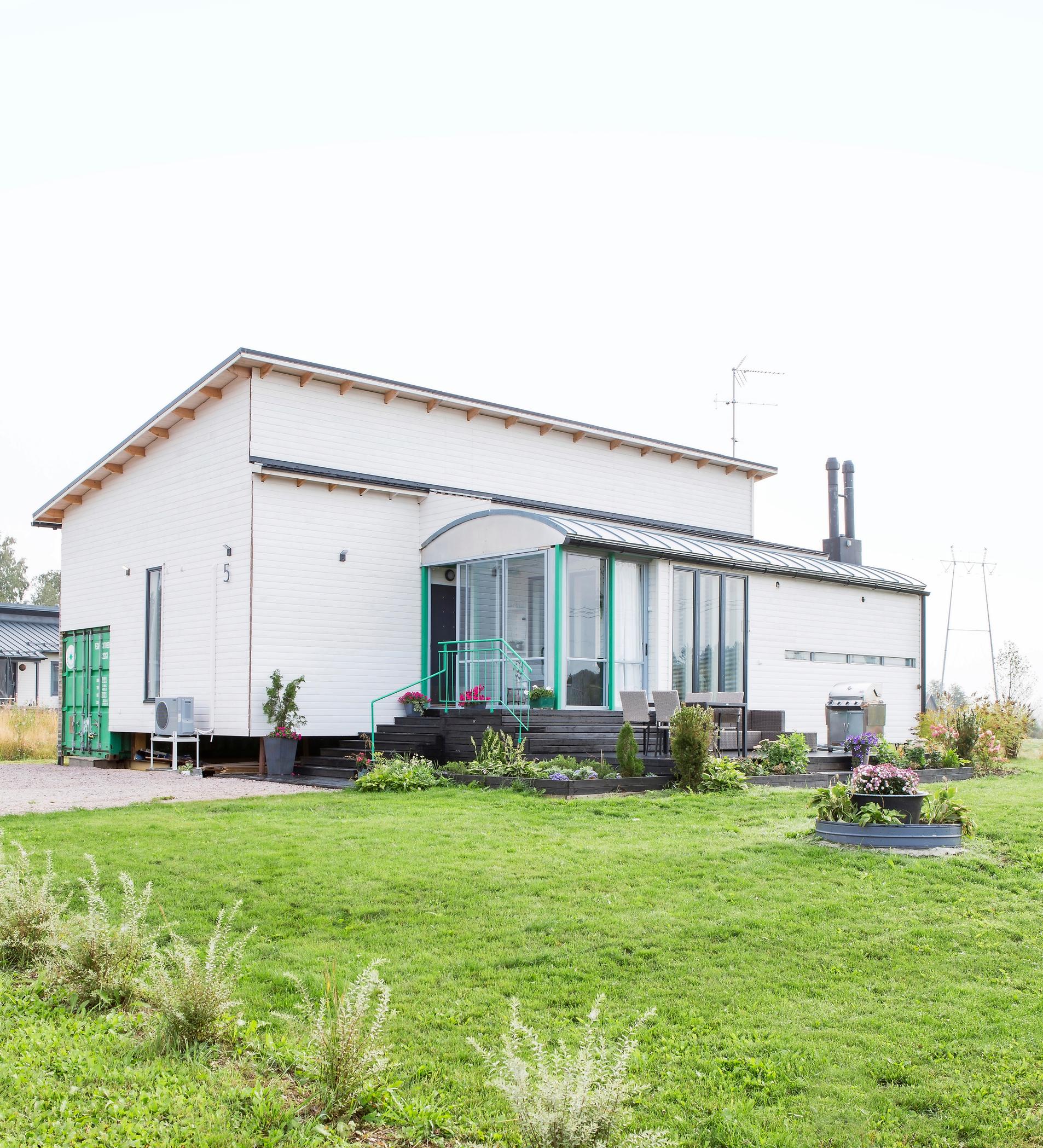 A house built from shipping containers and a grill kiosk