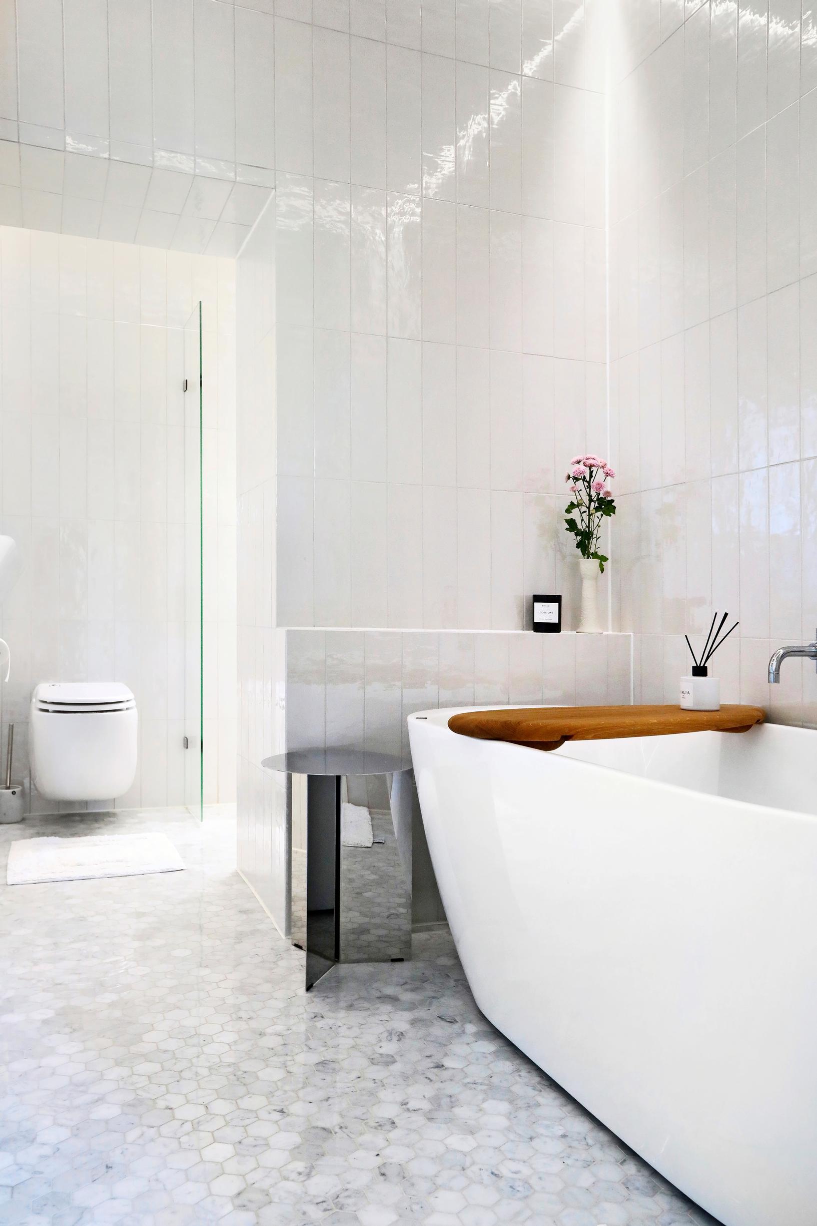 White-tiled bathroom with a bathtub