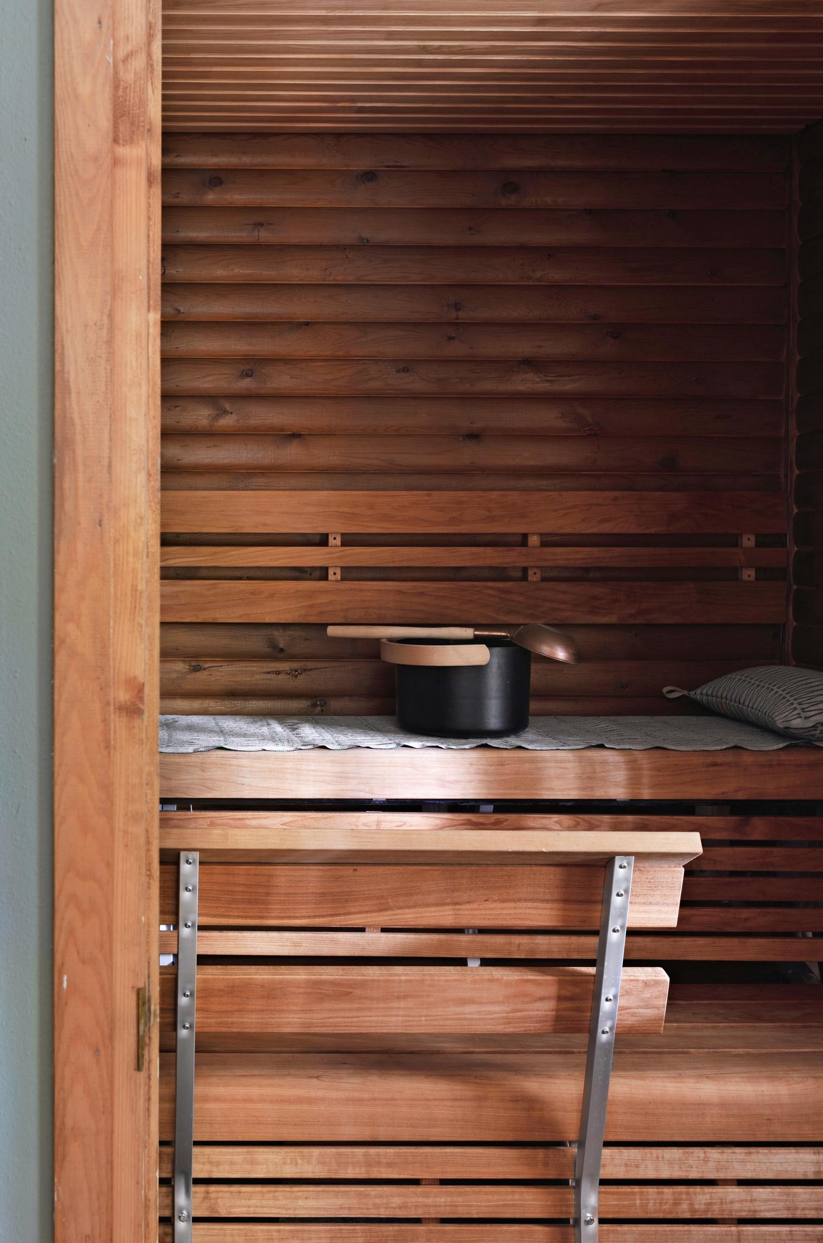 Black pail on sauna benches