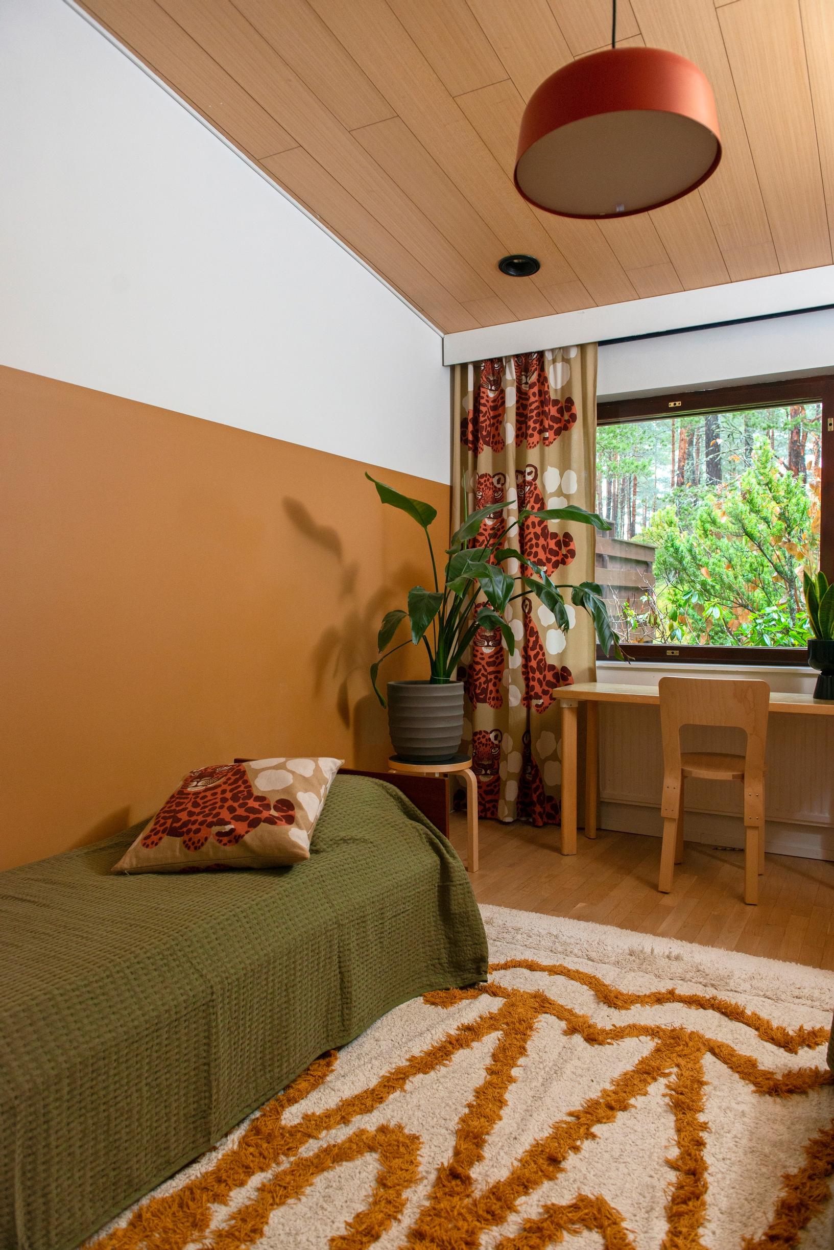 Image of a children's room in a 1980s rowhouse with a wall partially painted in muted orange.