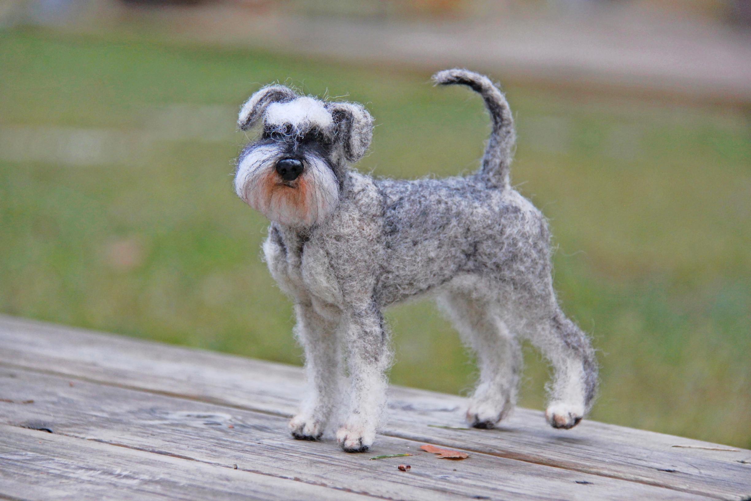 A miniature felted dog.