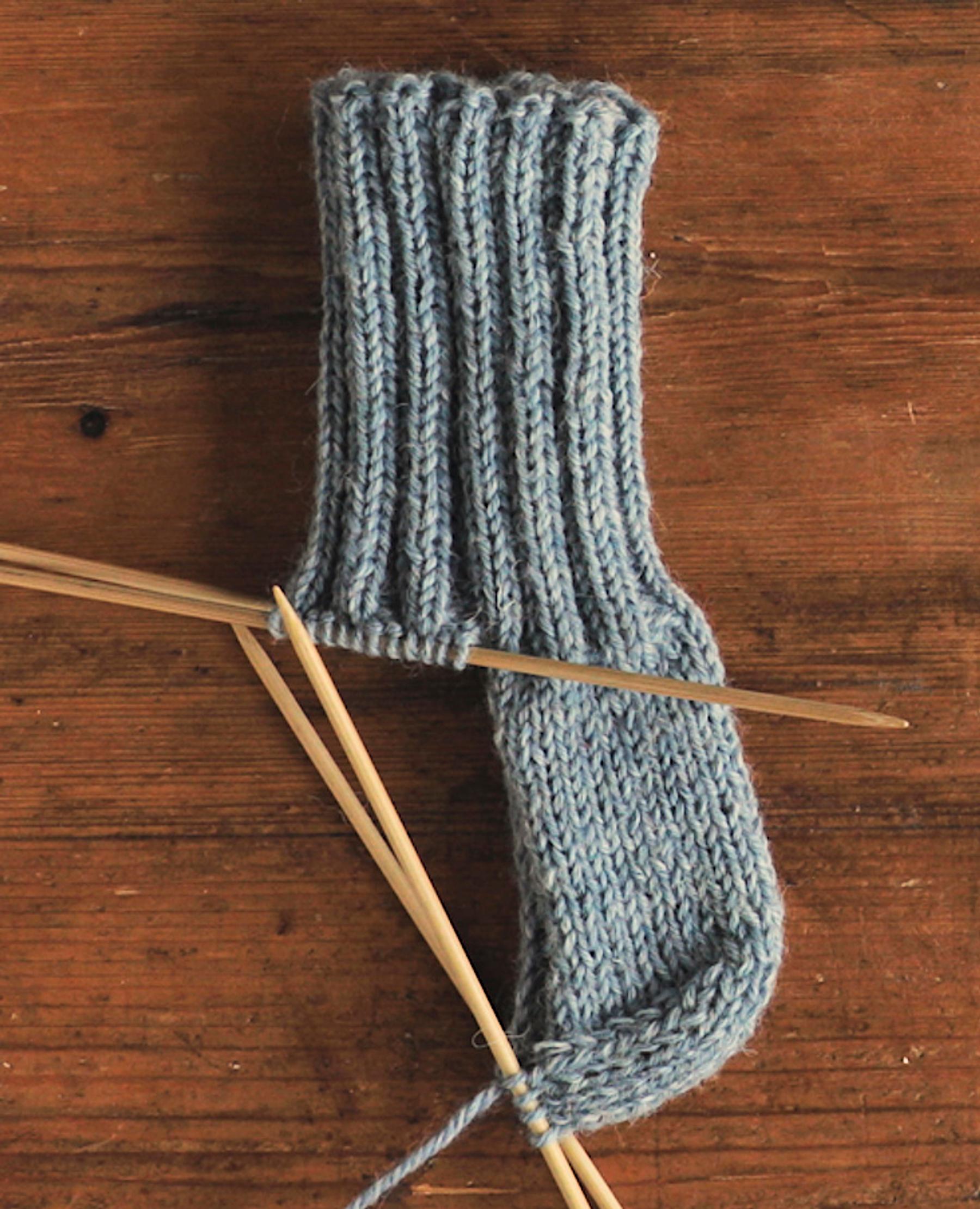 how to knit a sock heel: The completed heel flap and heel turn of the wool sock.