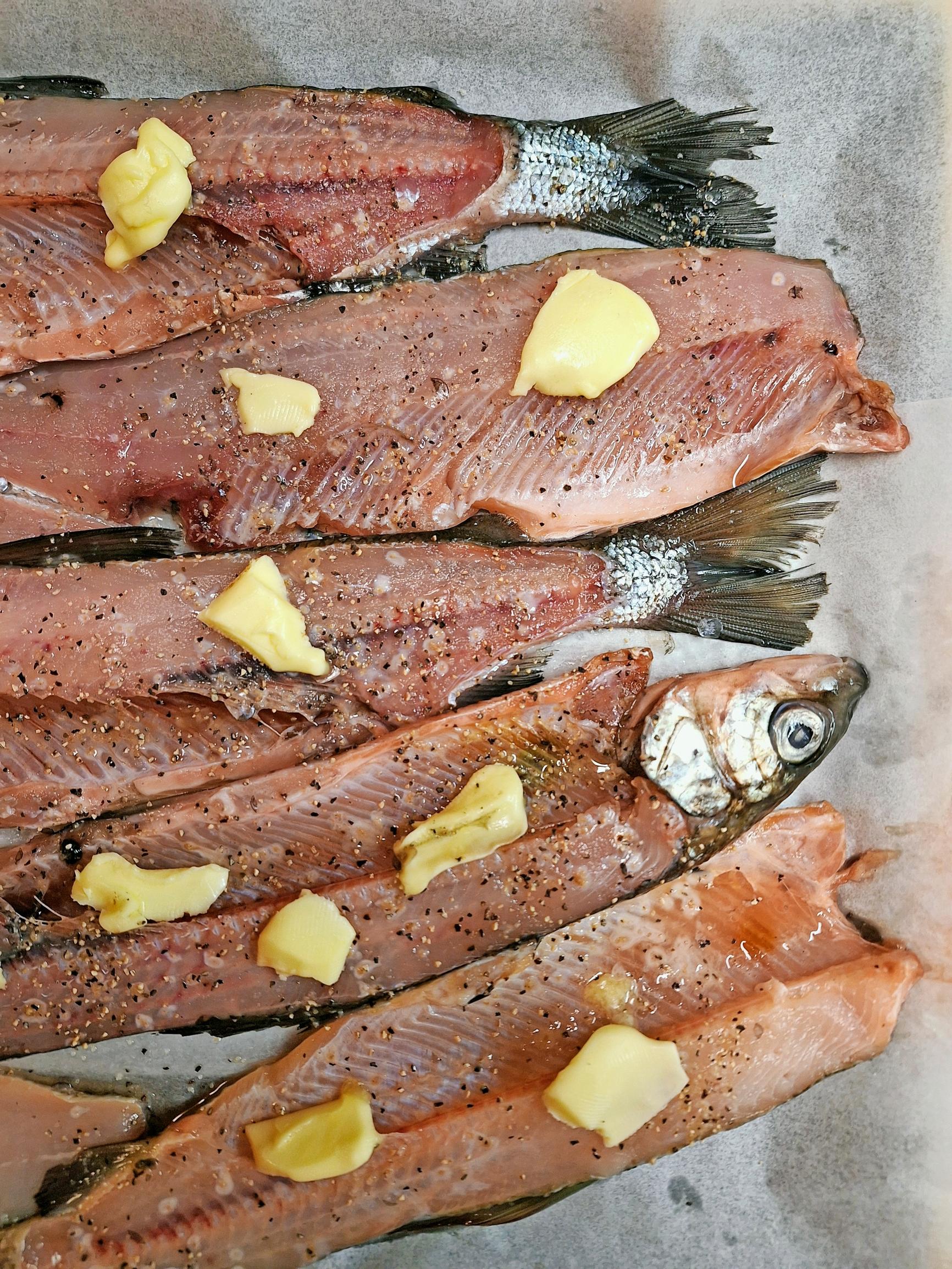 salmon fillets topped with pats of butter