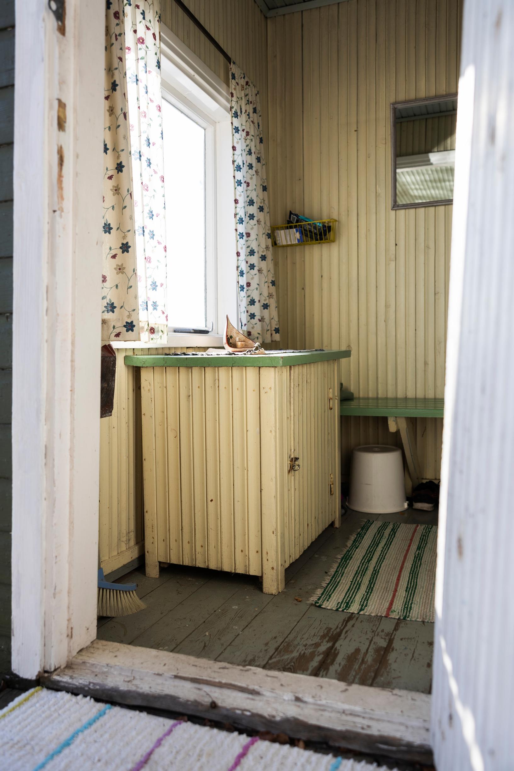 Old sauna chamber with a cabinet and rag rugs
