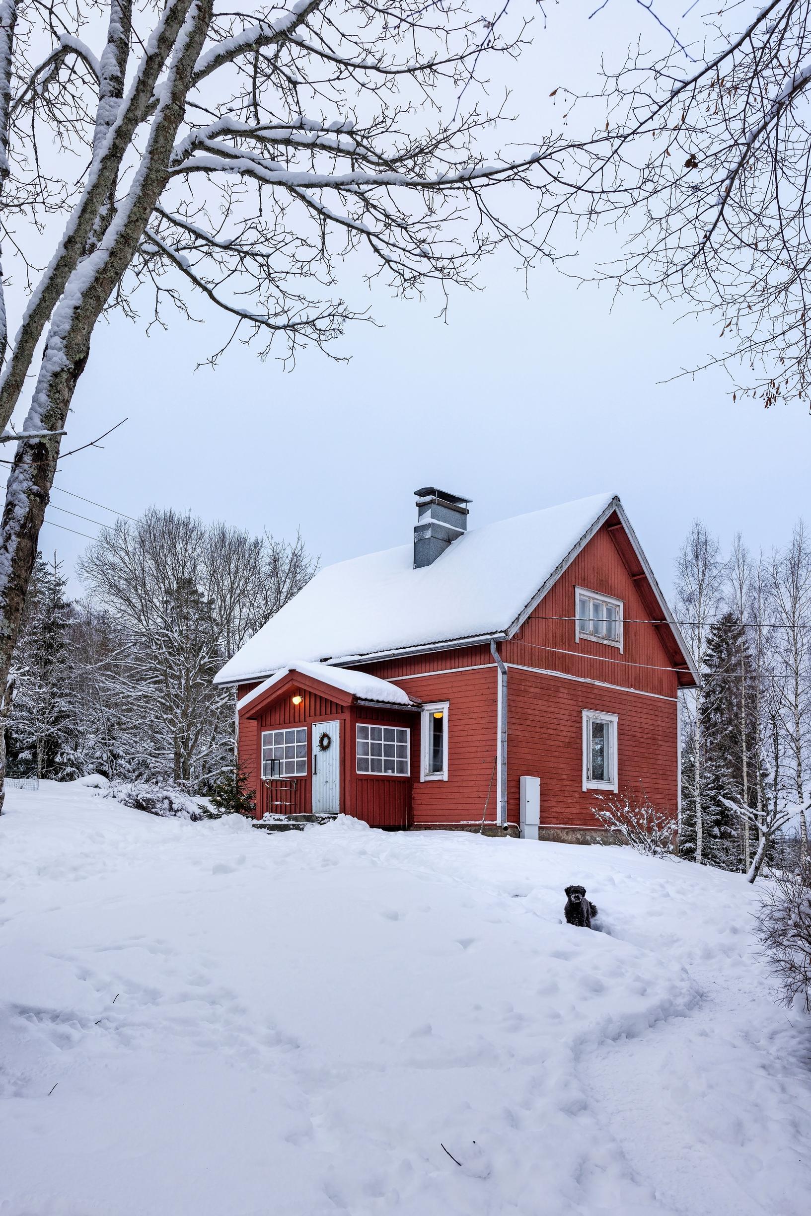 Elina and Klaus Aalto’s red cottage nestled in the snow