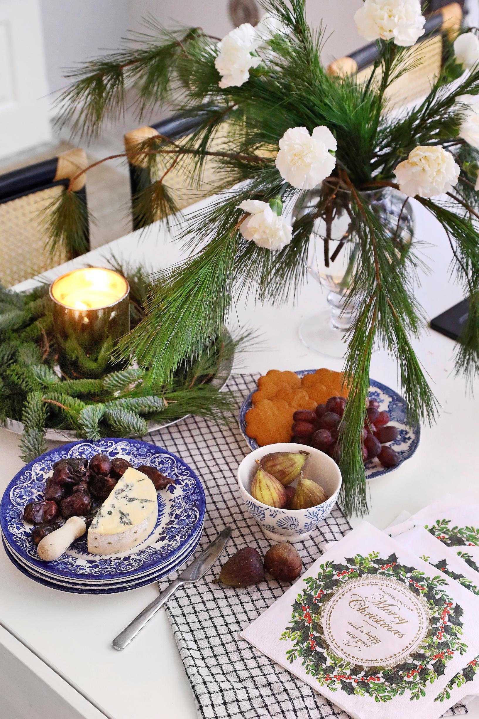 A festive bouquet on the table combining Christmas treats with evergreens and flowers