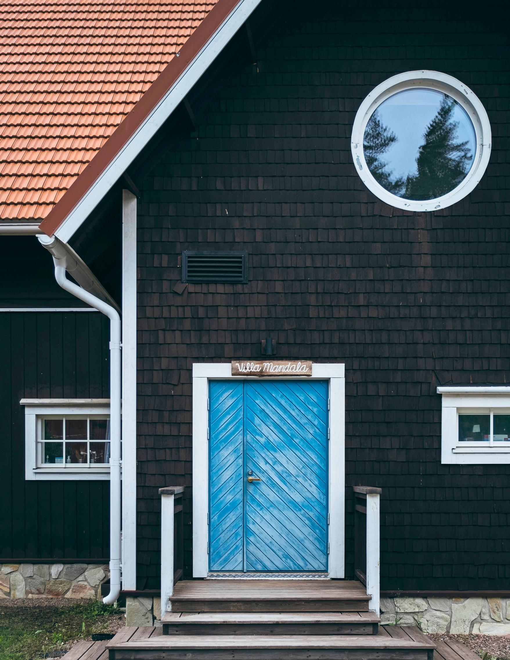 The light-blue main door of Villa Mandala