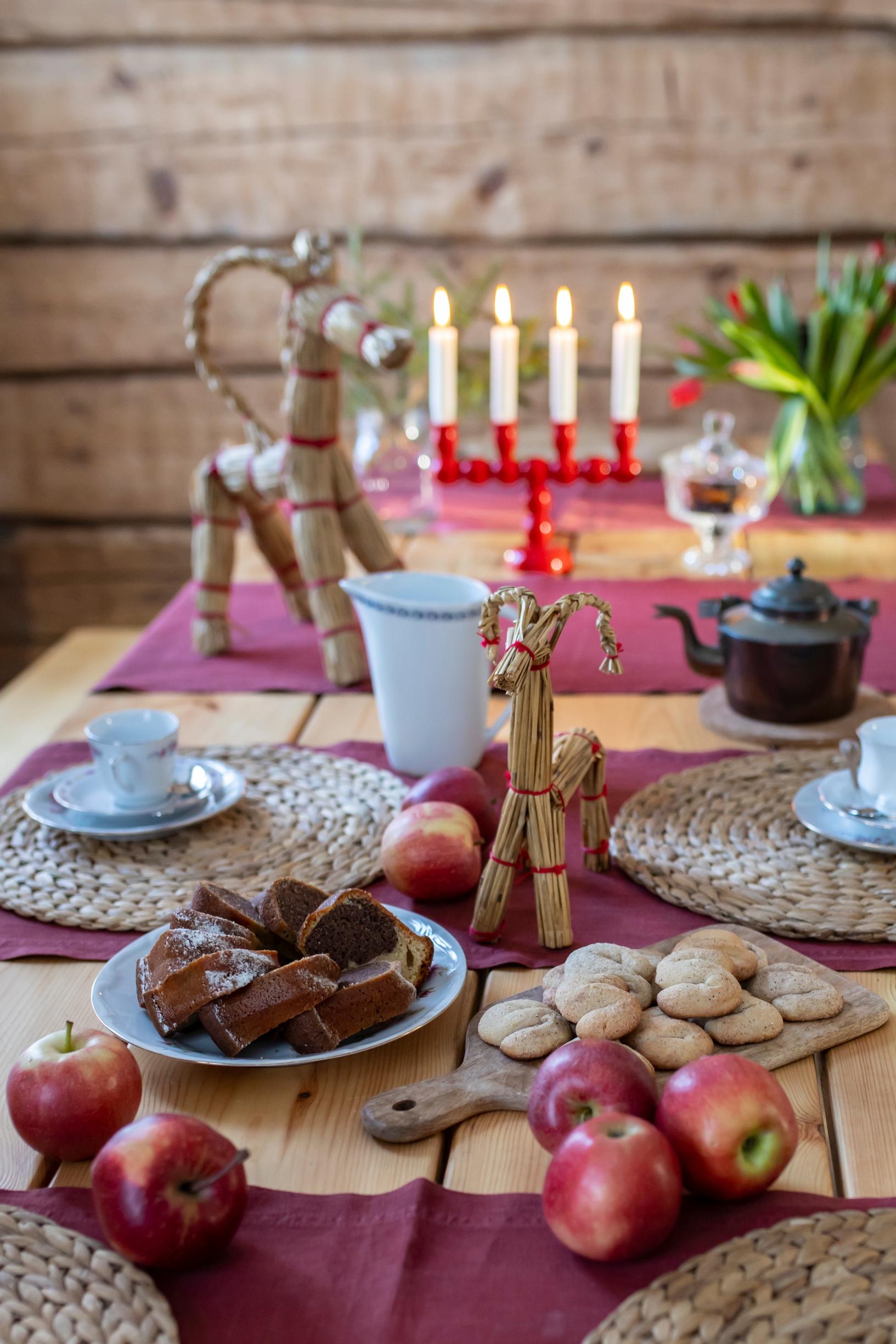 A traditional Christmas table setting with straw goats in the vicarage’s everyday kitchen