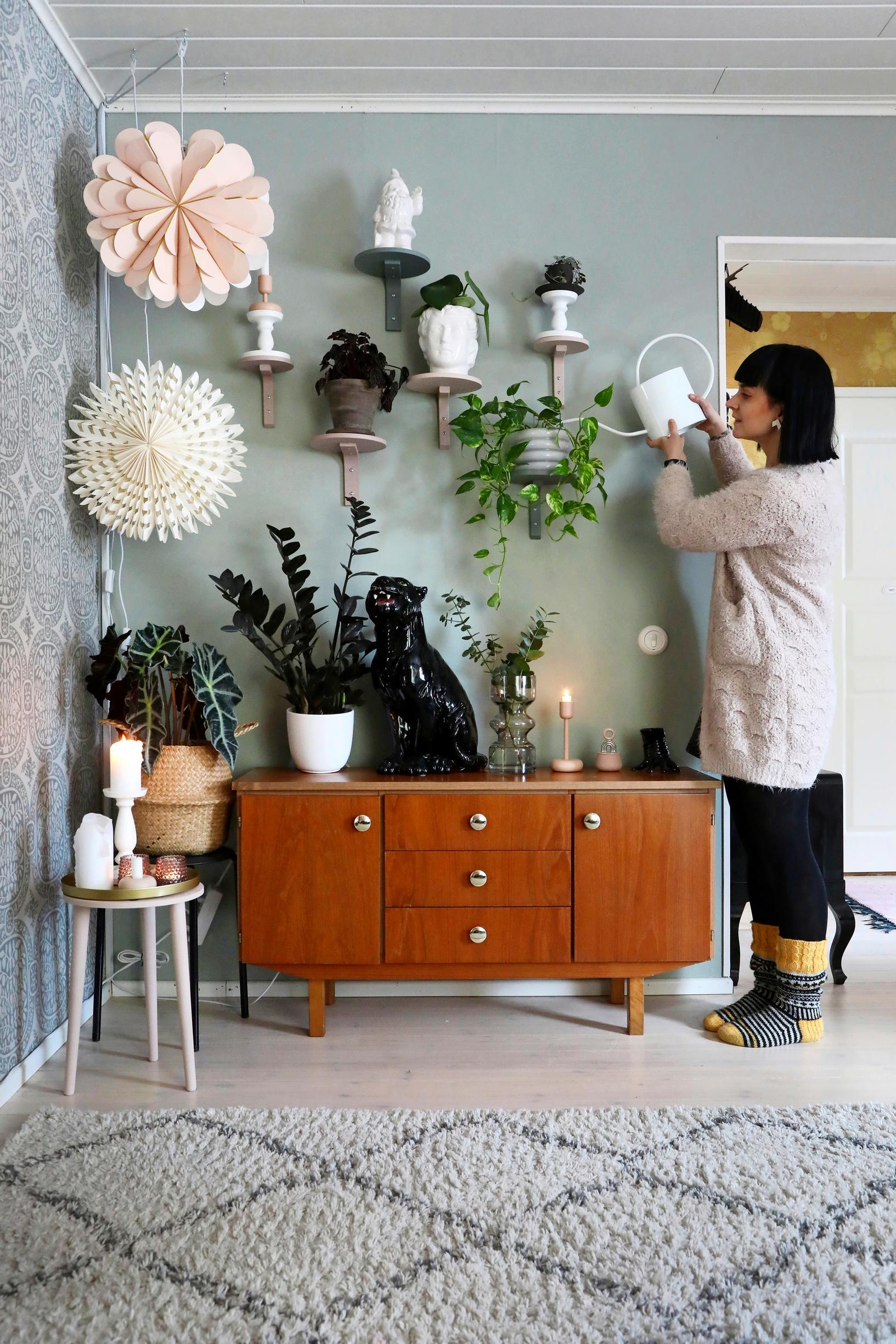 Outi watering houseplants