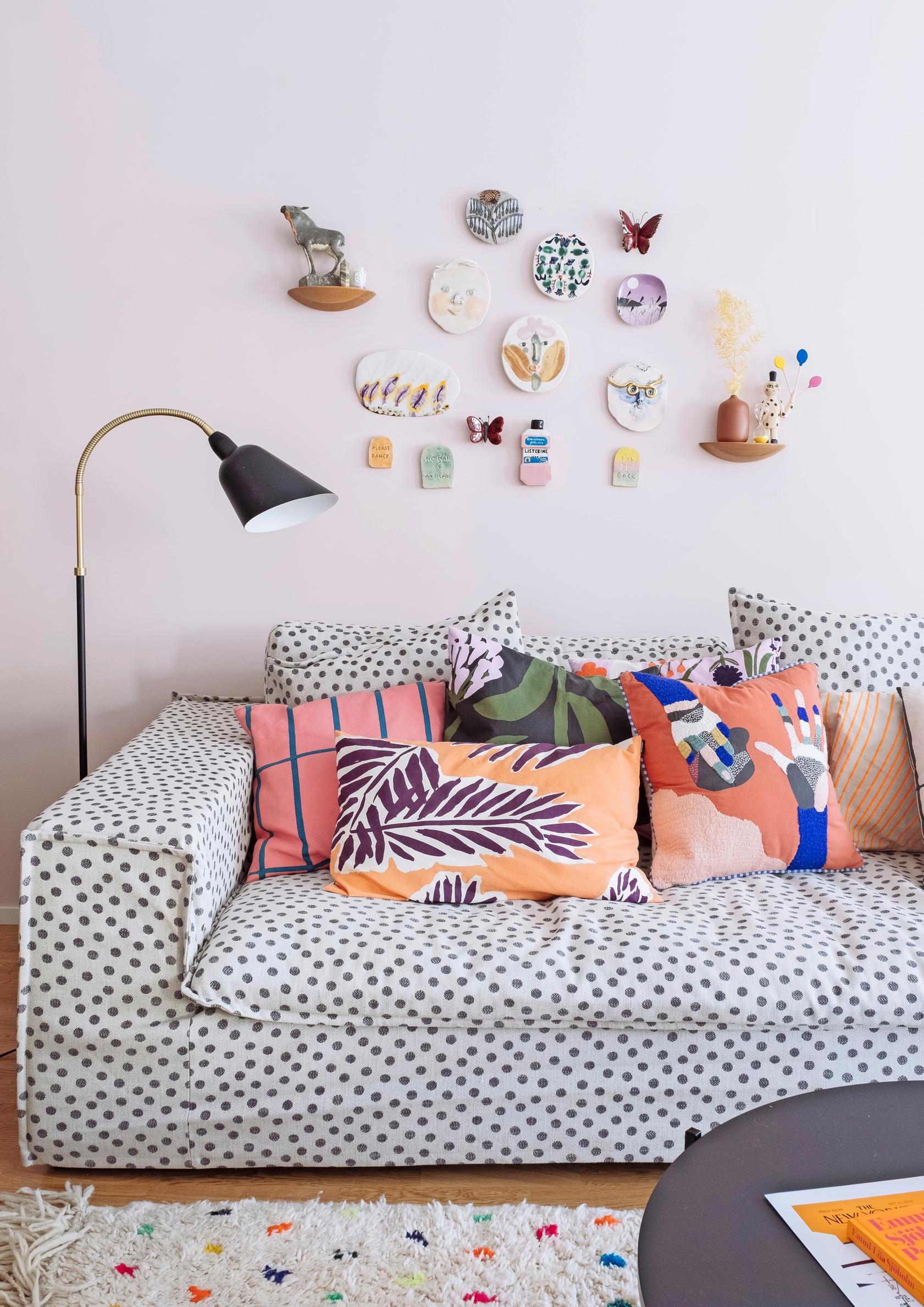 A spotted living room sofa with artwork above it