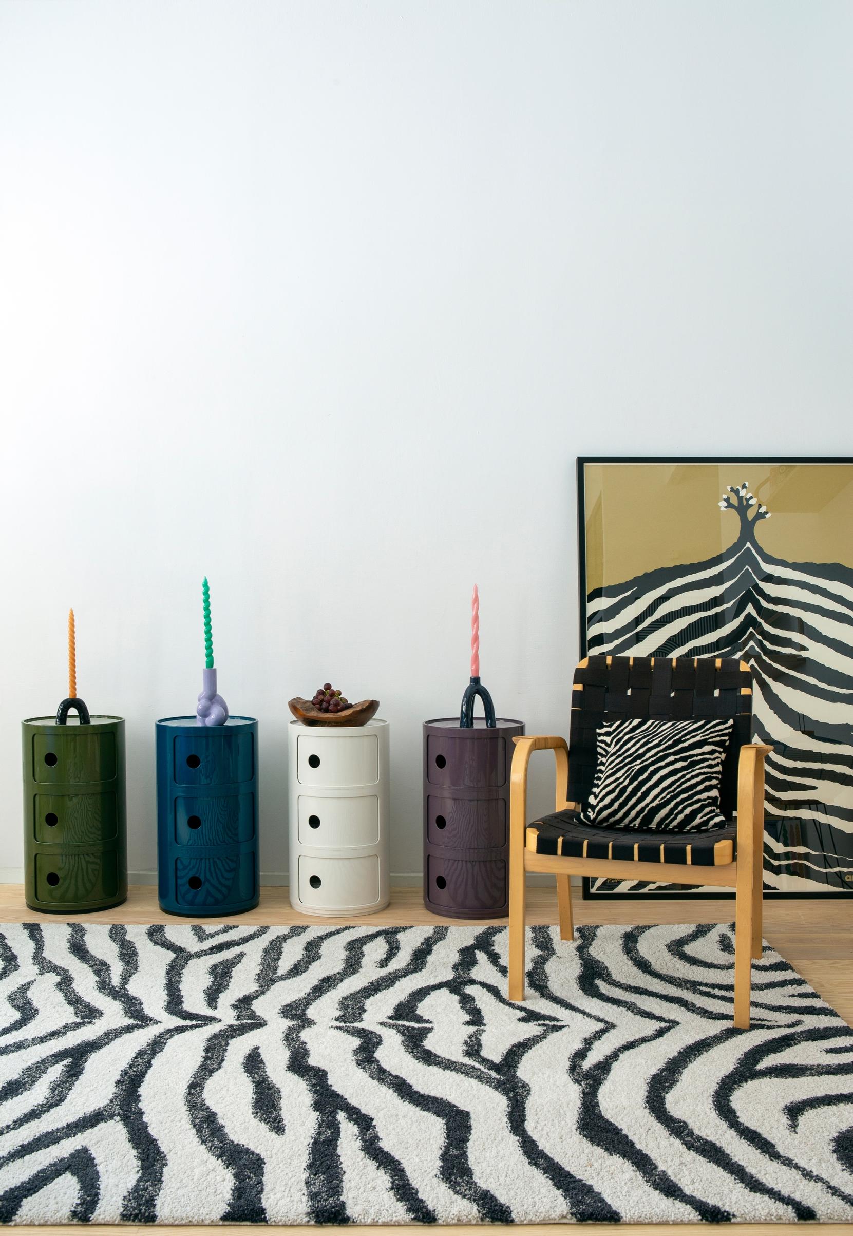 Kartell’s differently colored Componibili storage units and zebra-patterned textiles
