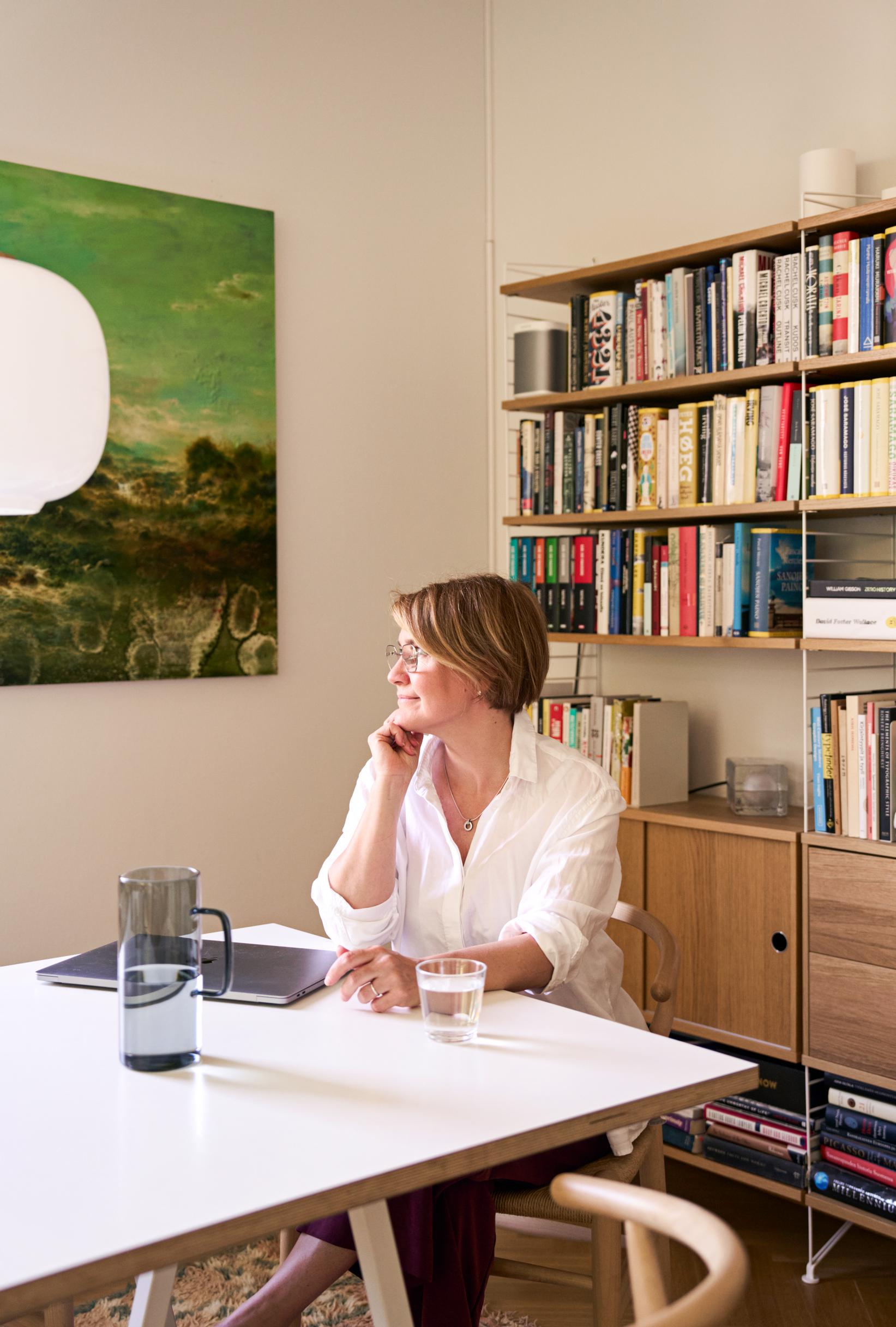 Photo of a woman at the dining table.