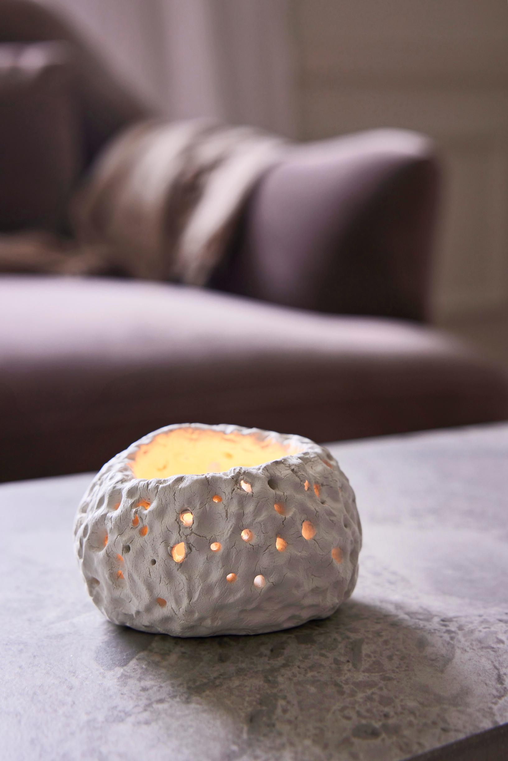 A tea‑light lantern on a table.