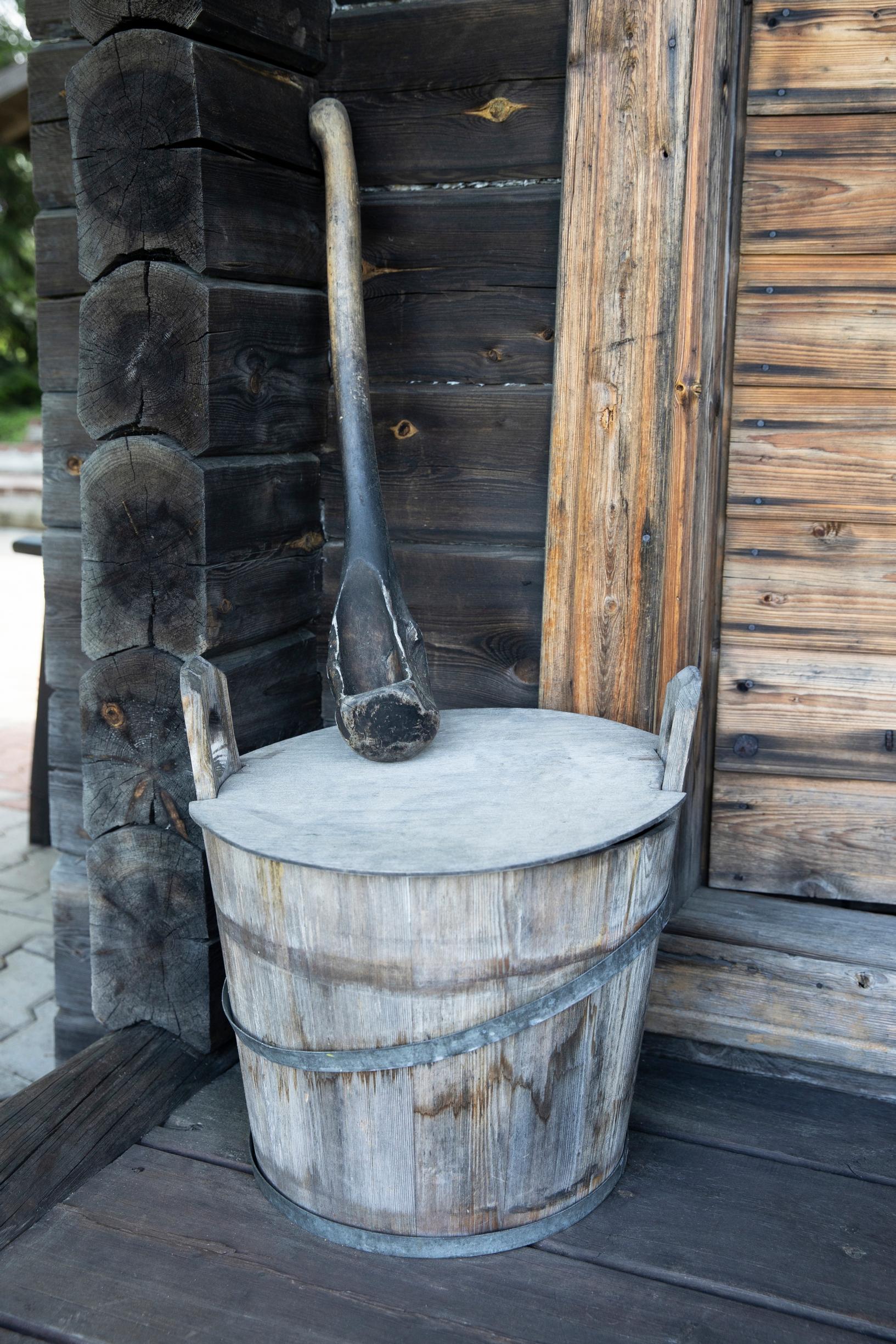An old, patinated sauna ladle on the whiskey barrel sauna terrace