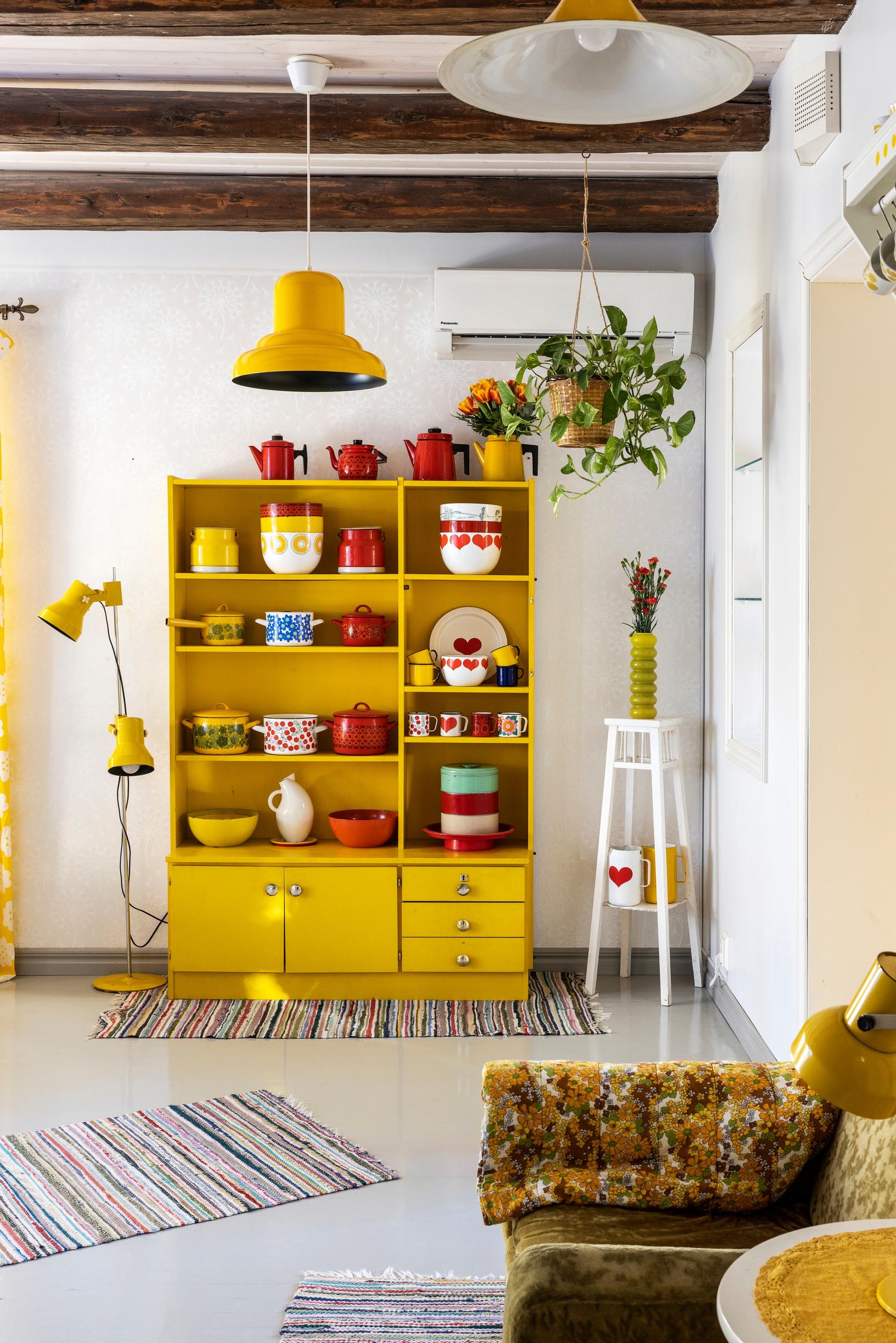 A yellow shelf and a Finel enamelware collection.