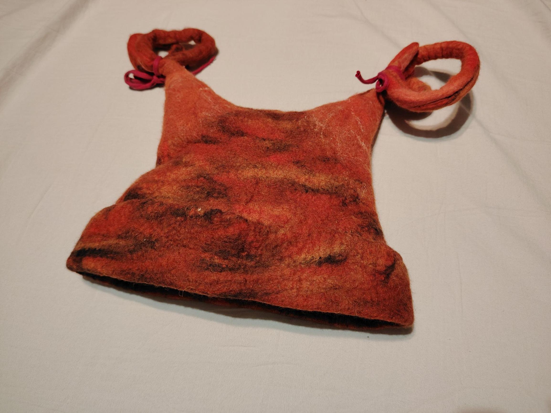 A felted sauna hat with swirls on top.