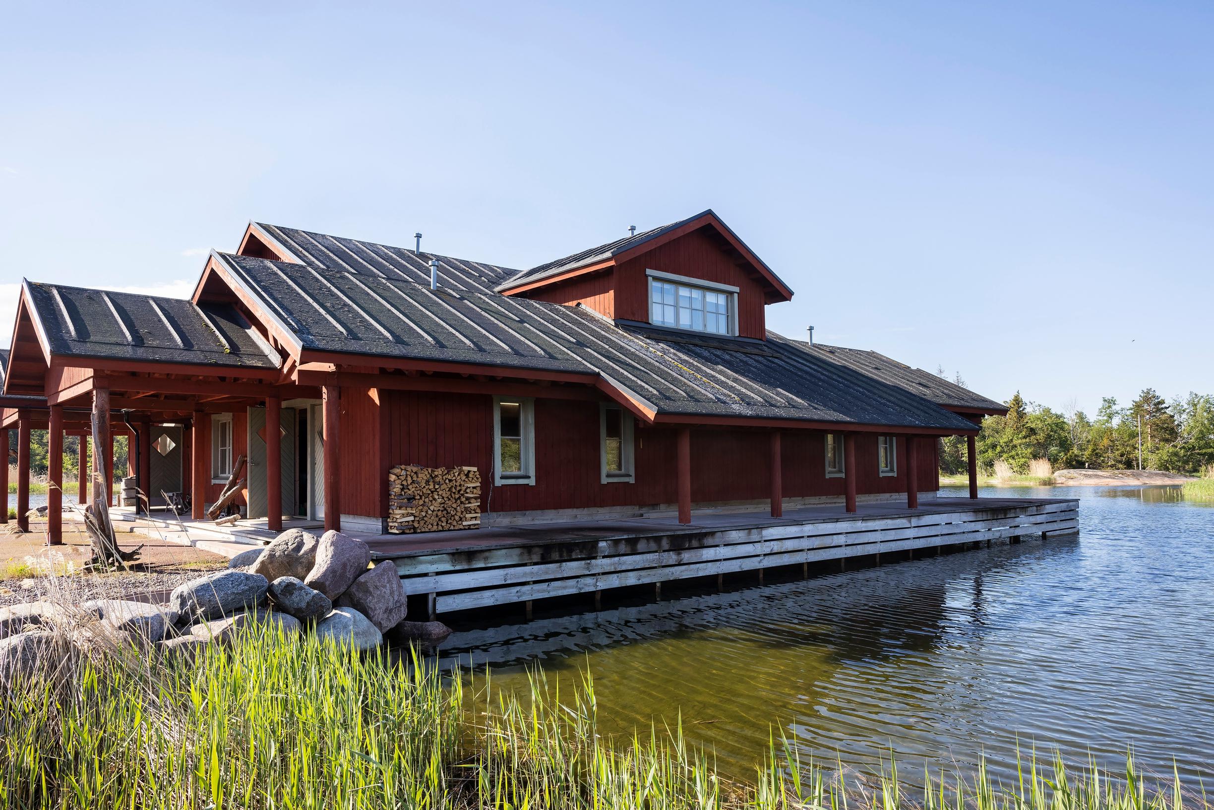 An over 400-square-meter boathouse painted red by the sea.