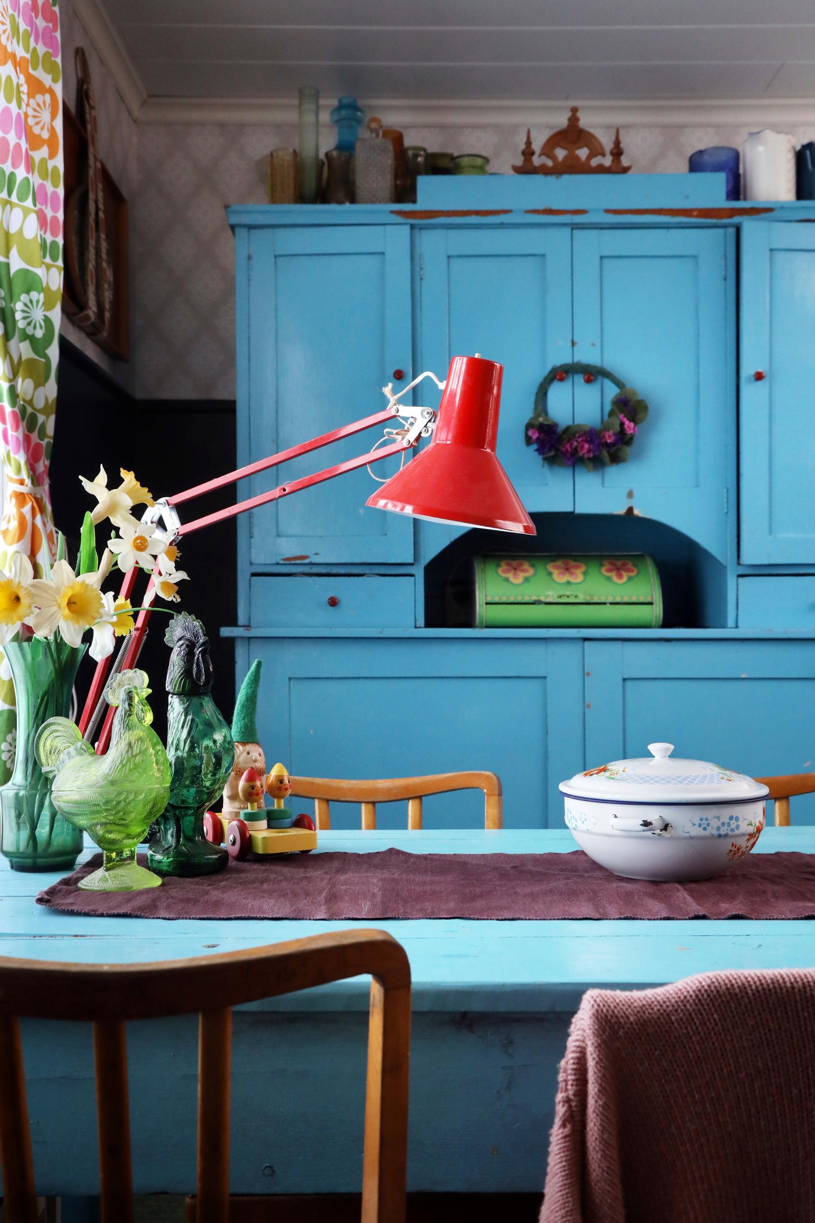 A blue dish cabinet and kitchen table.