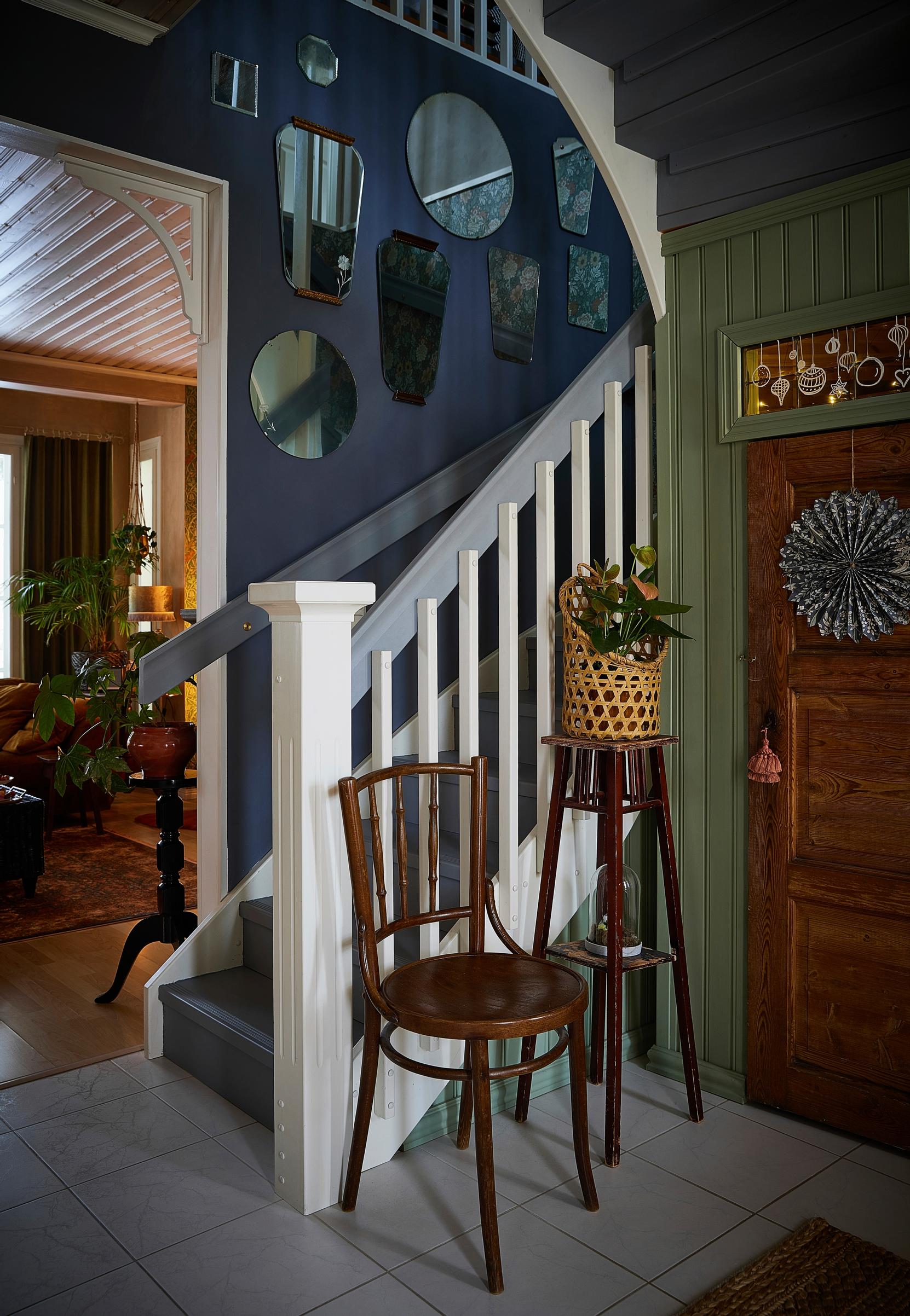 Under the staircase closet and on the wall, a mirror collage