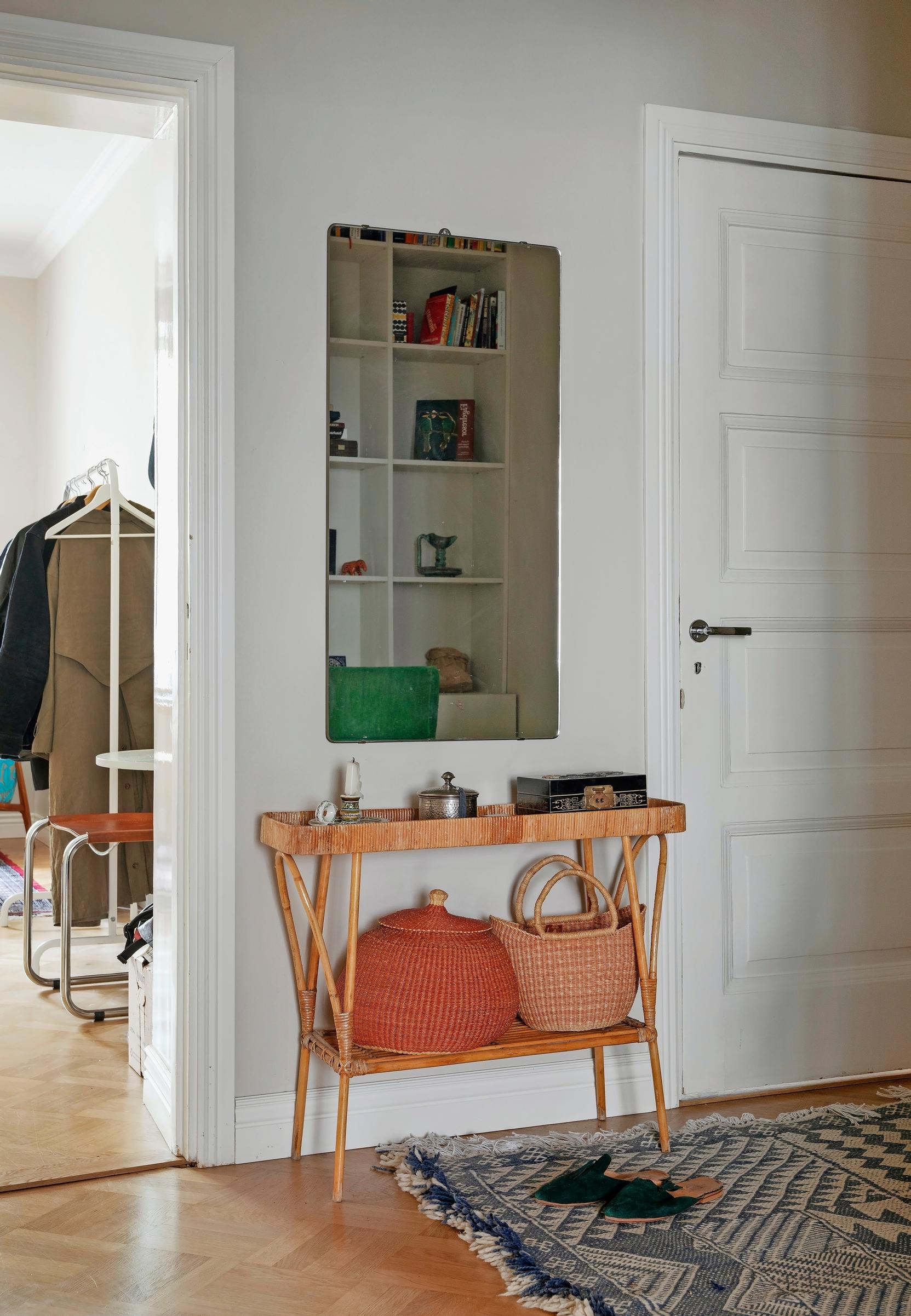 Image of an entryway with a rattan table.