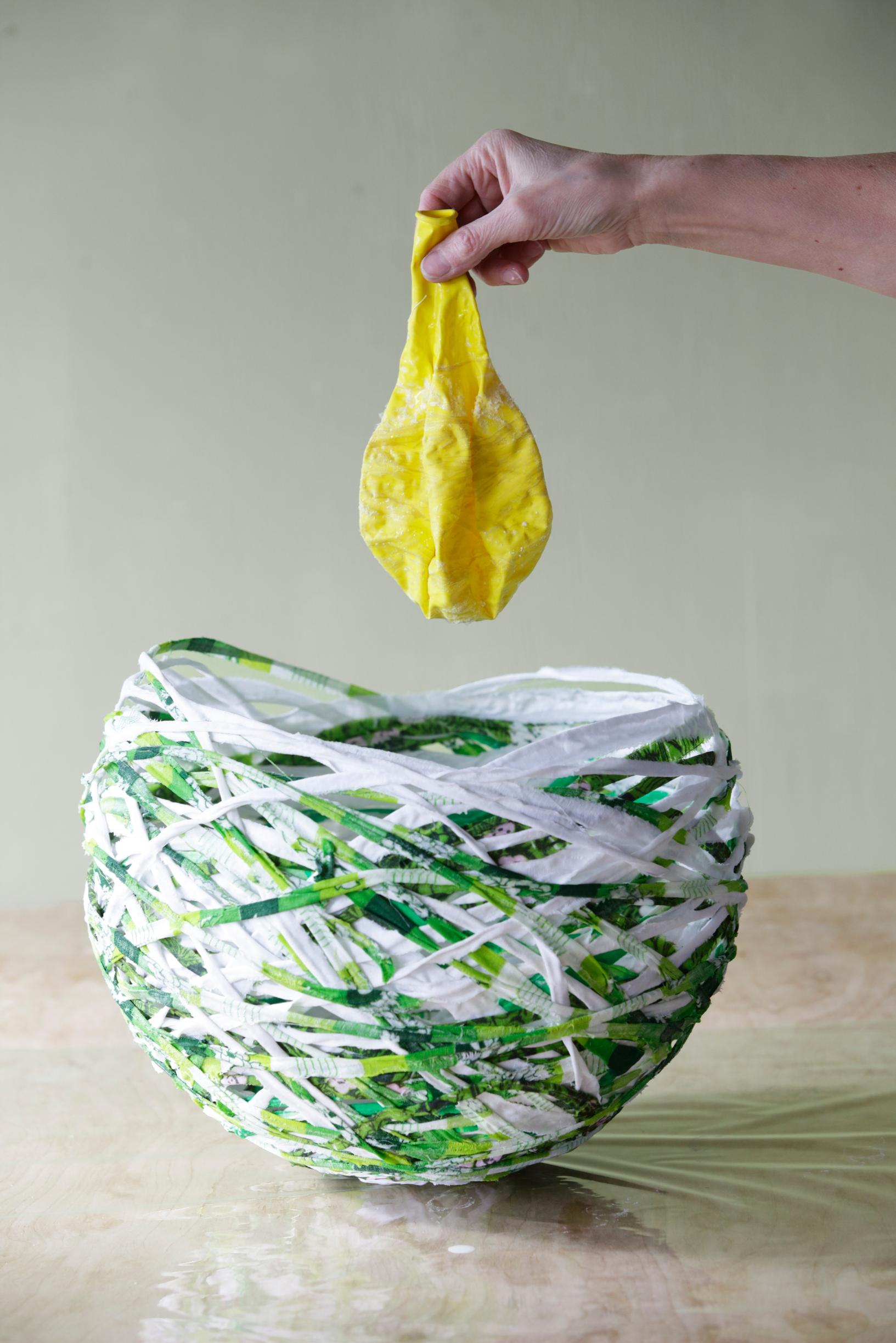 Deflating the balloon from inside the bowl