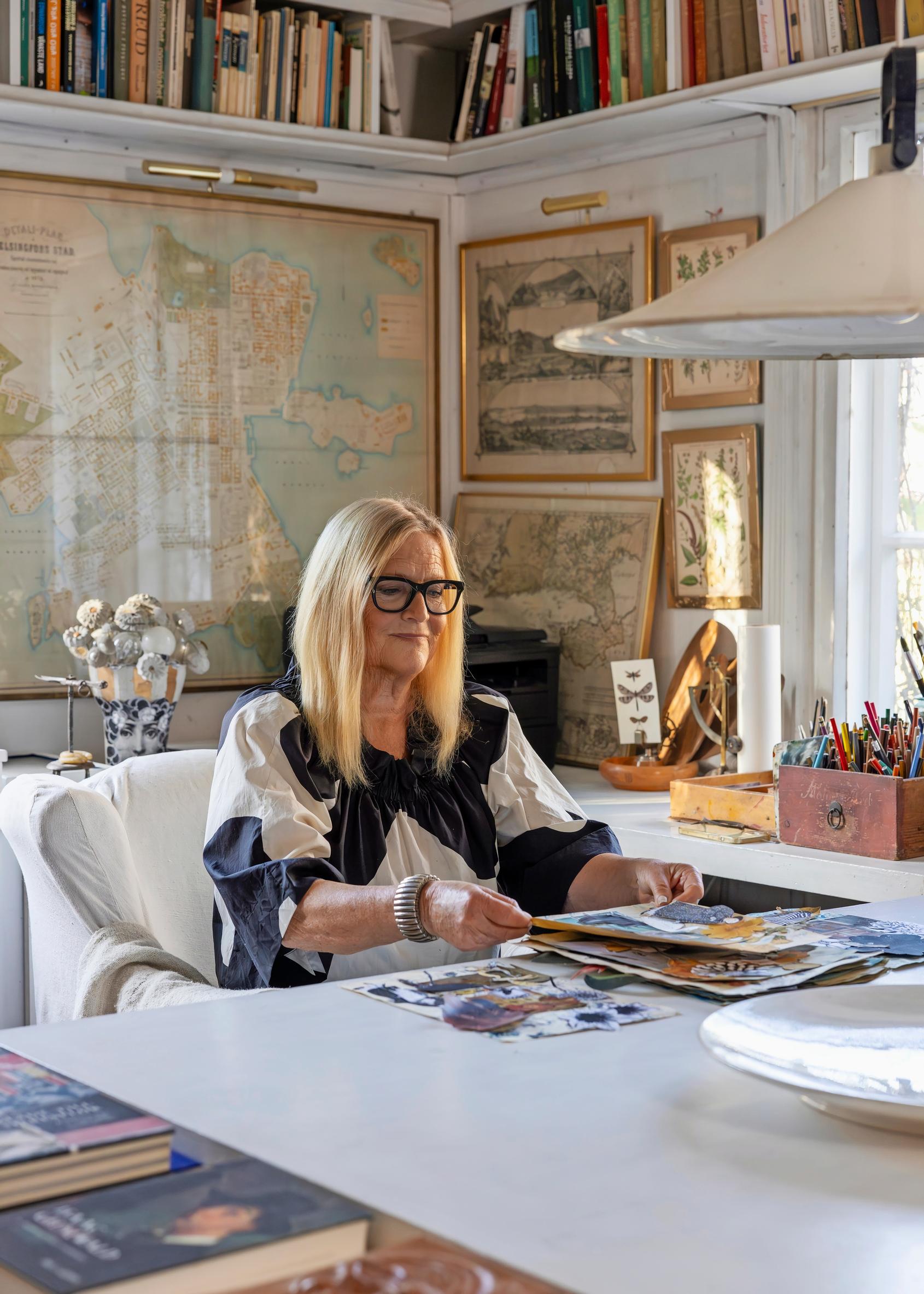 Kerstin Enbom sits at a table in her library.
