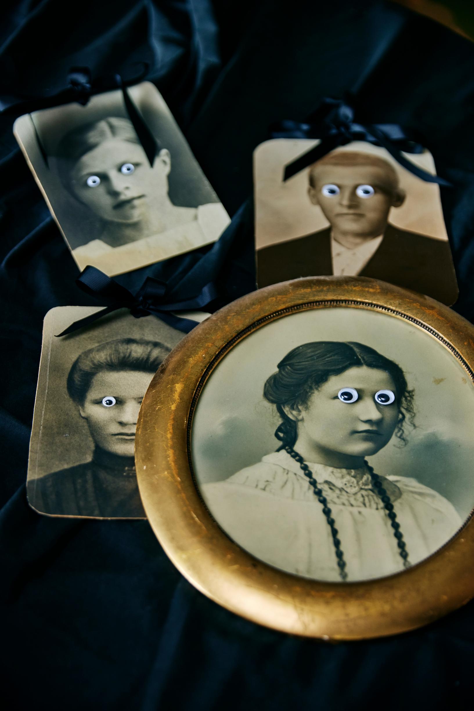 Portraits with sticker eyes on them.