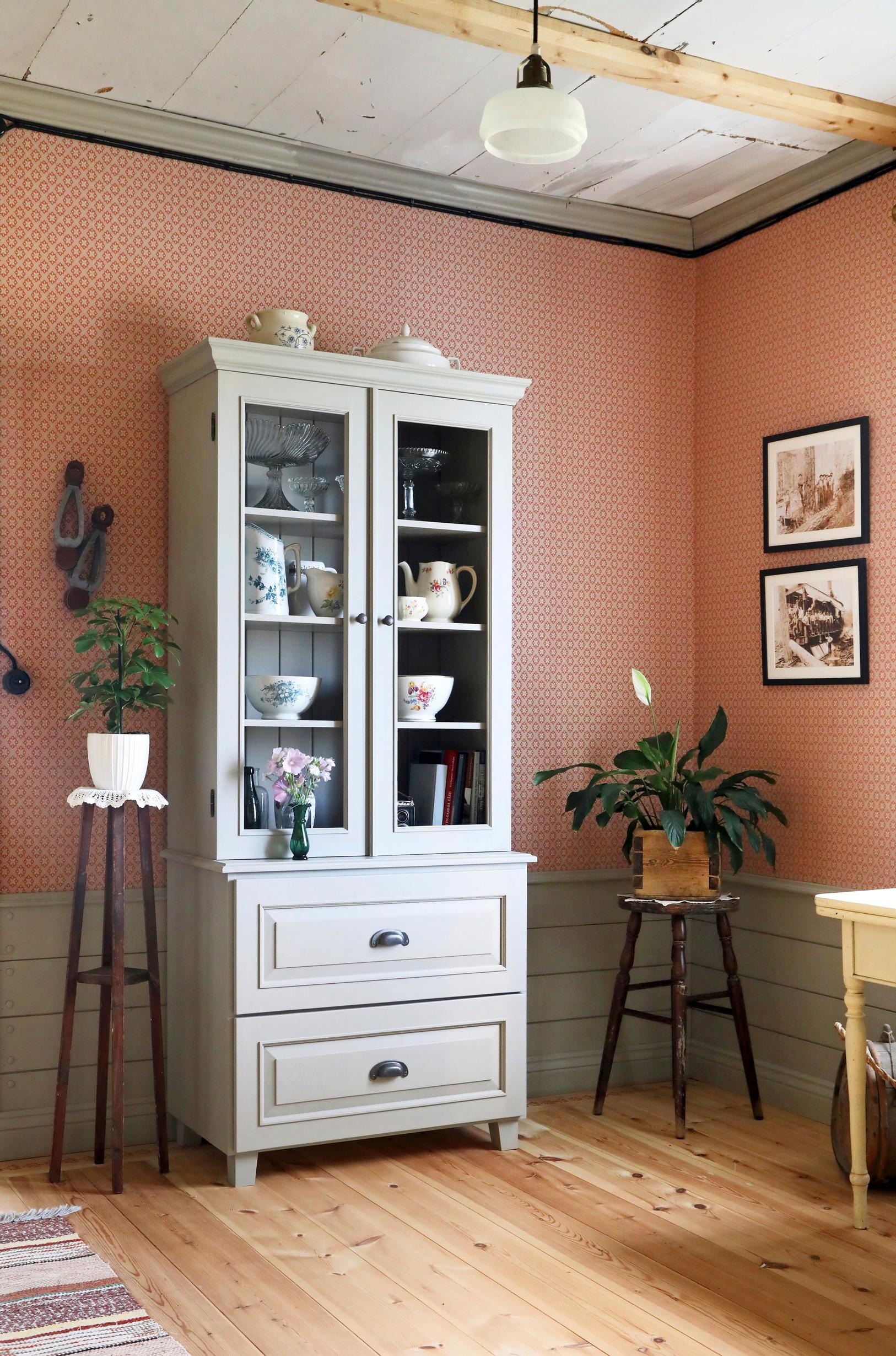 Display cabinet and red patterned wallpaper