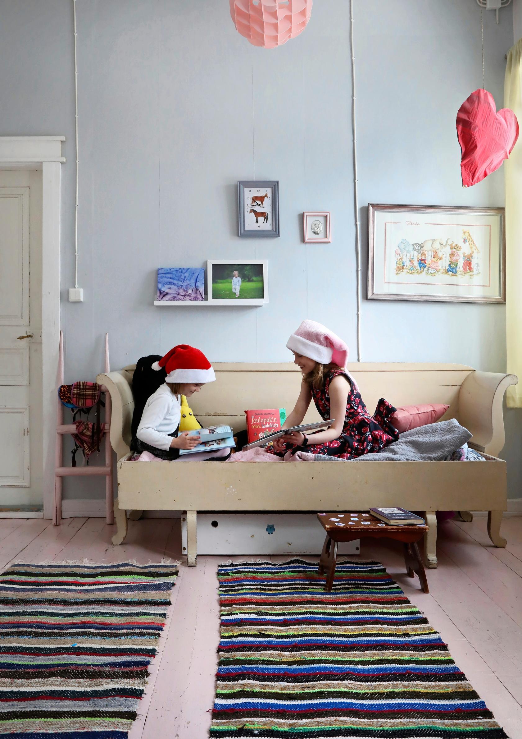 The children sitting on a wooden sofa