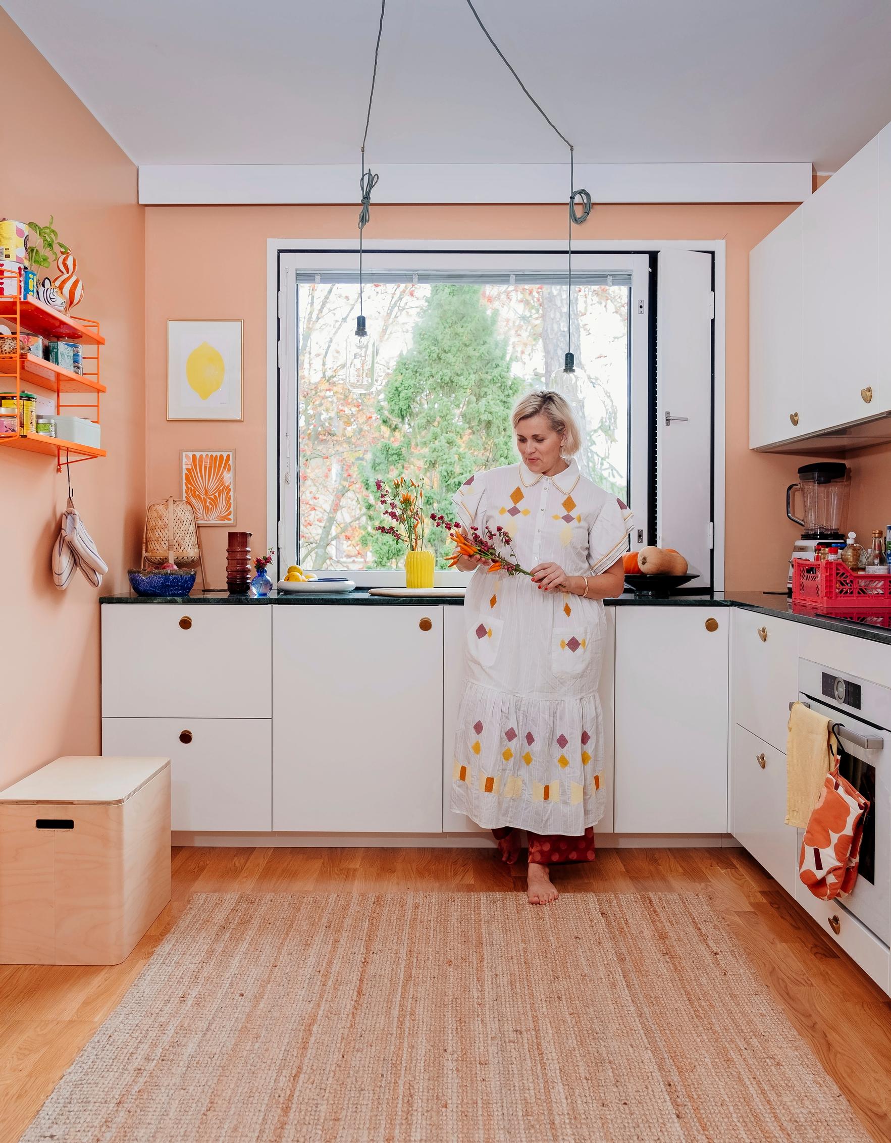 Elina in a bright kitchen featuring green marble countertops