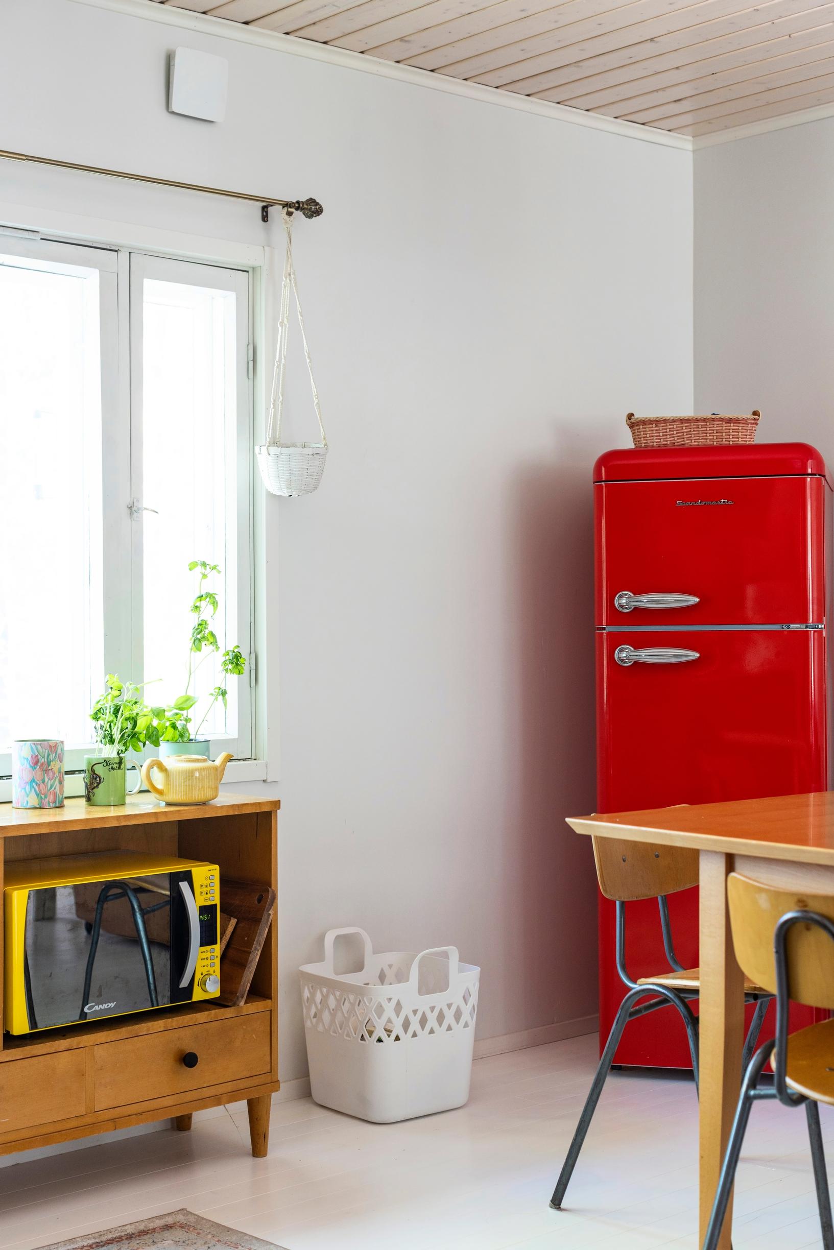 A red refrigerator in the cottage kitchen