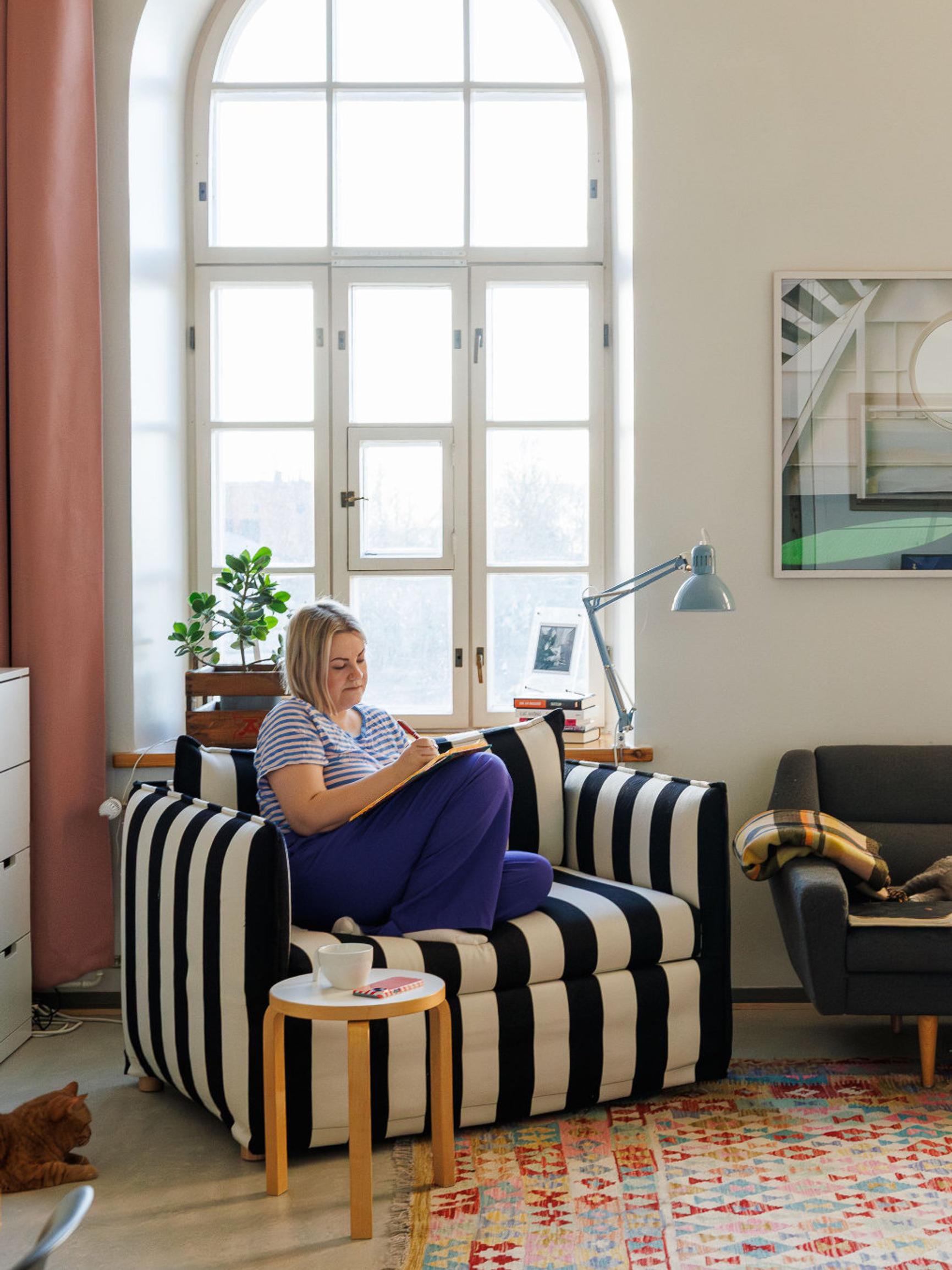 Laura’s candy-colored island home features four-meter-high ceilings and massive arched windows