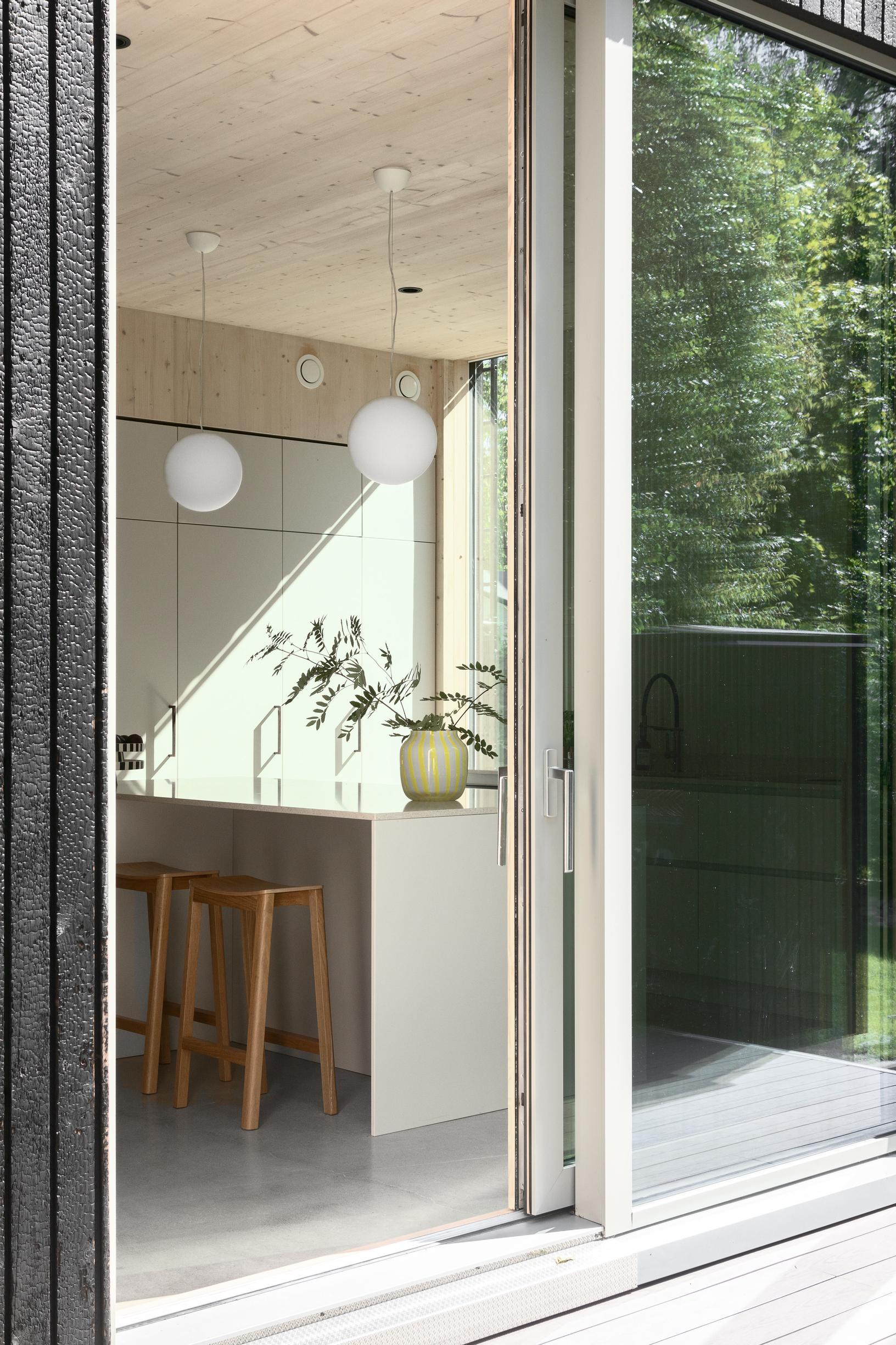 A glass sliding door leads from the kitchen to the terrace.