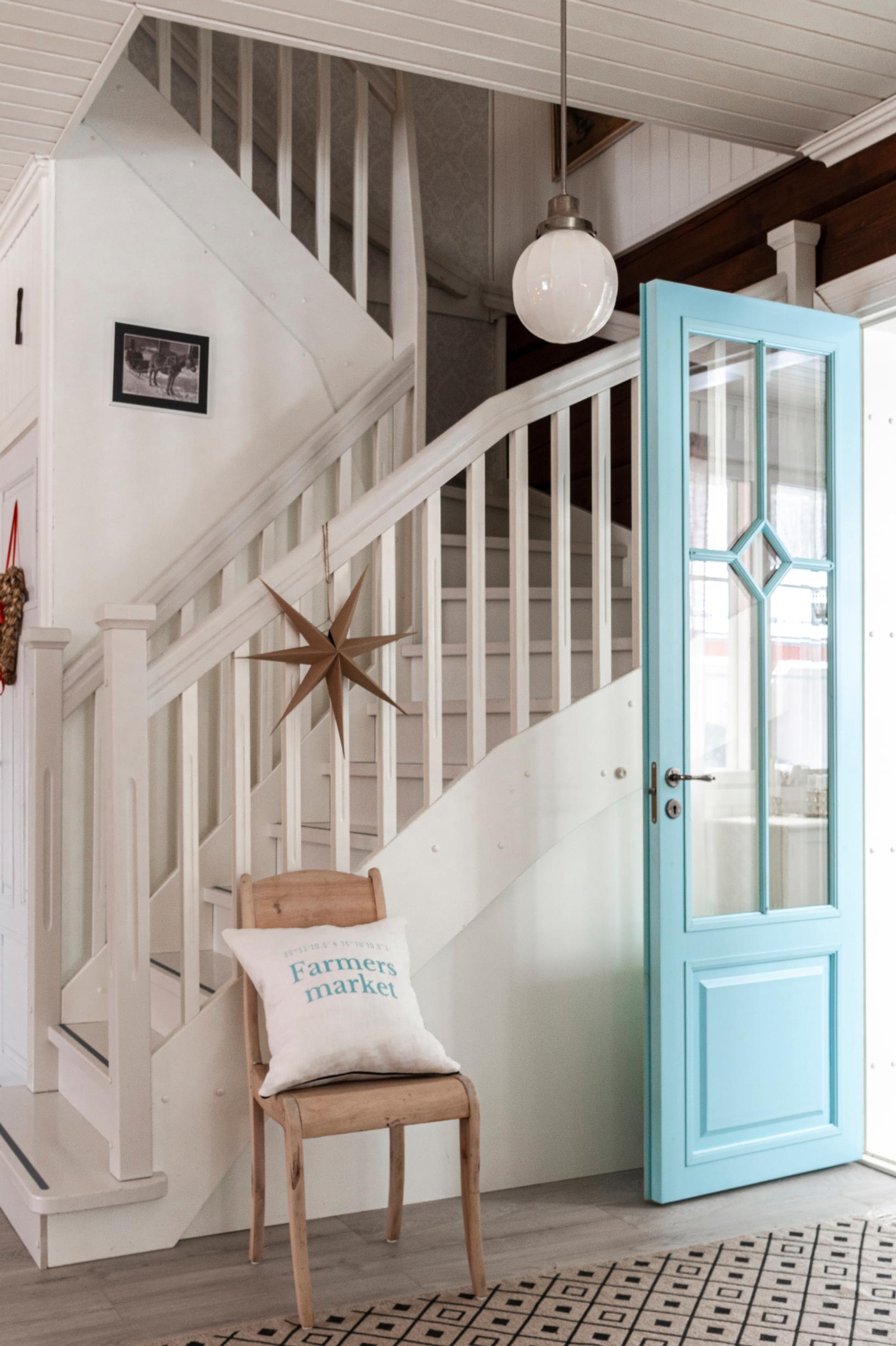 A turquoise door near the staircase