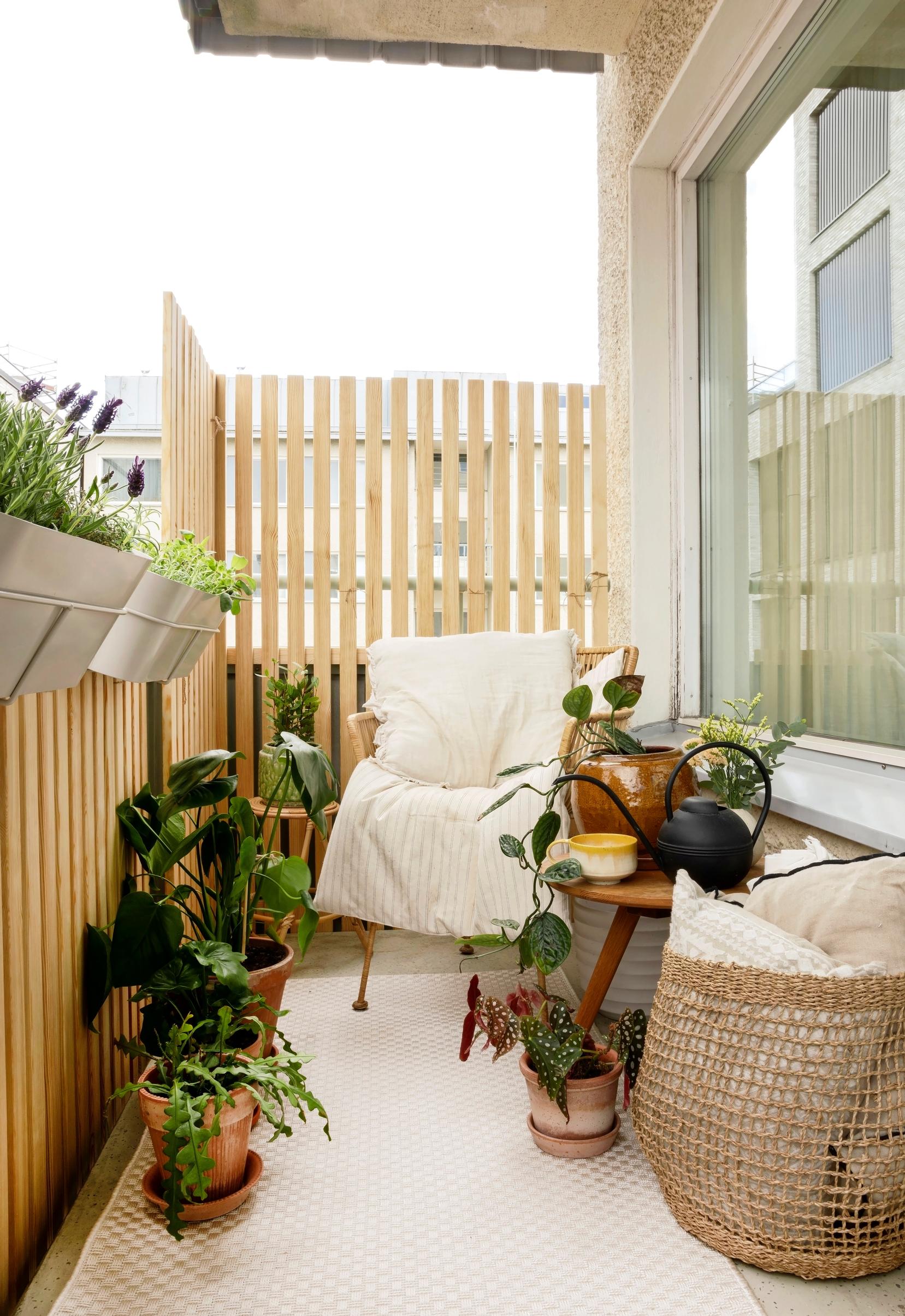 A cozy balcony surrounded by wooden slatting.