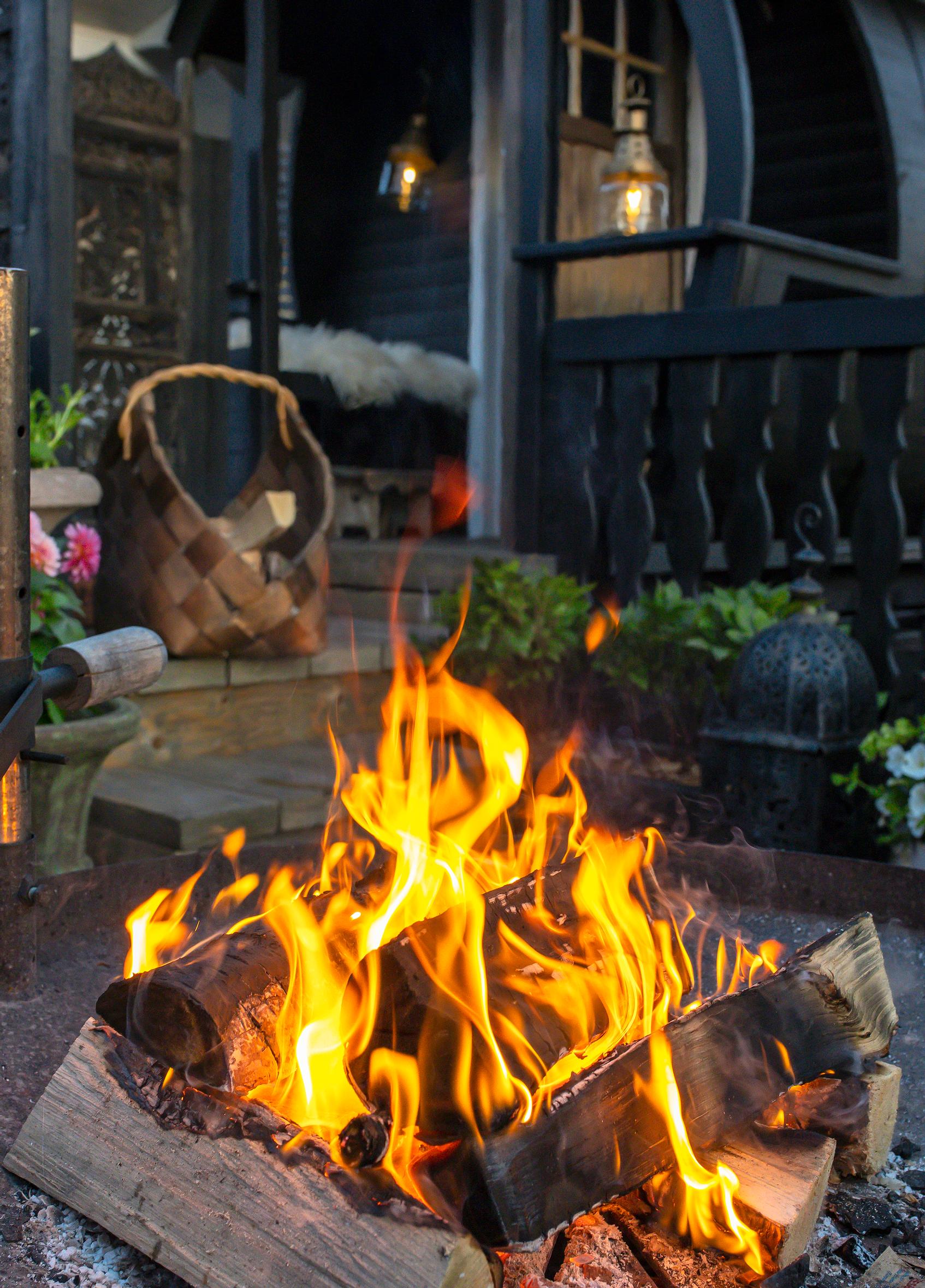 A campfire in the garden of a detached house