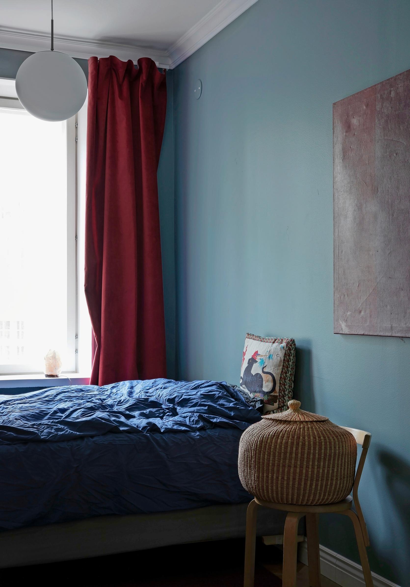 Image of a bedroom with blue walls.