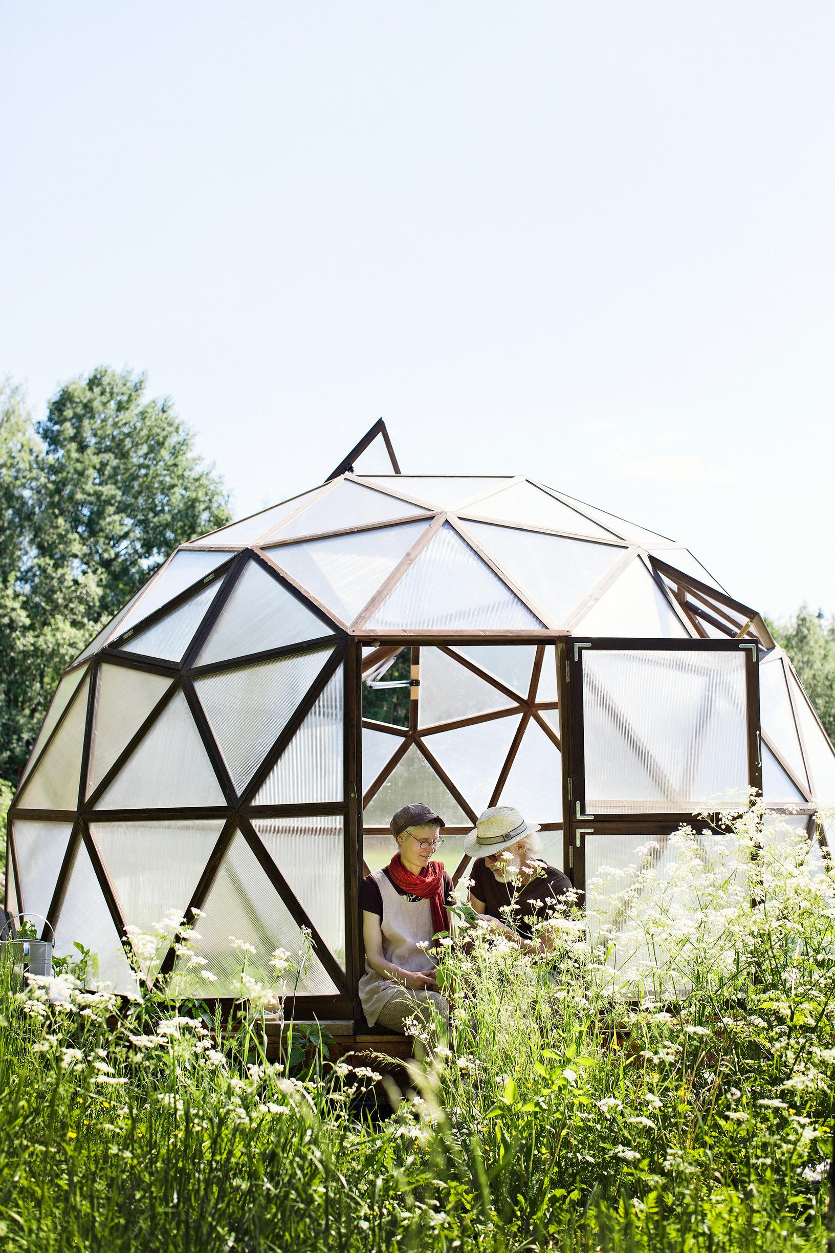 Geodesic greenhouse in a permaculture garden