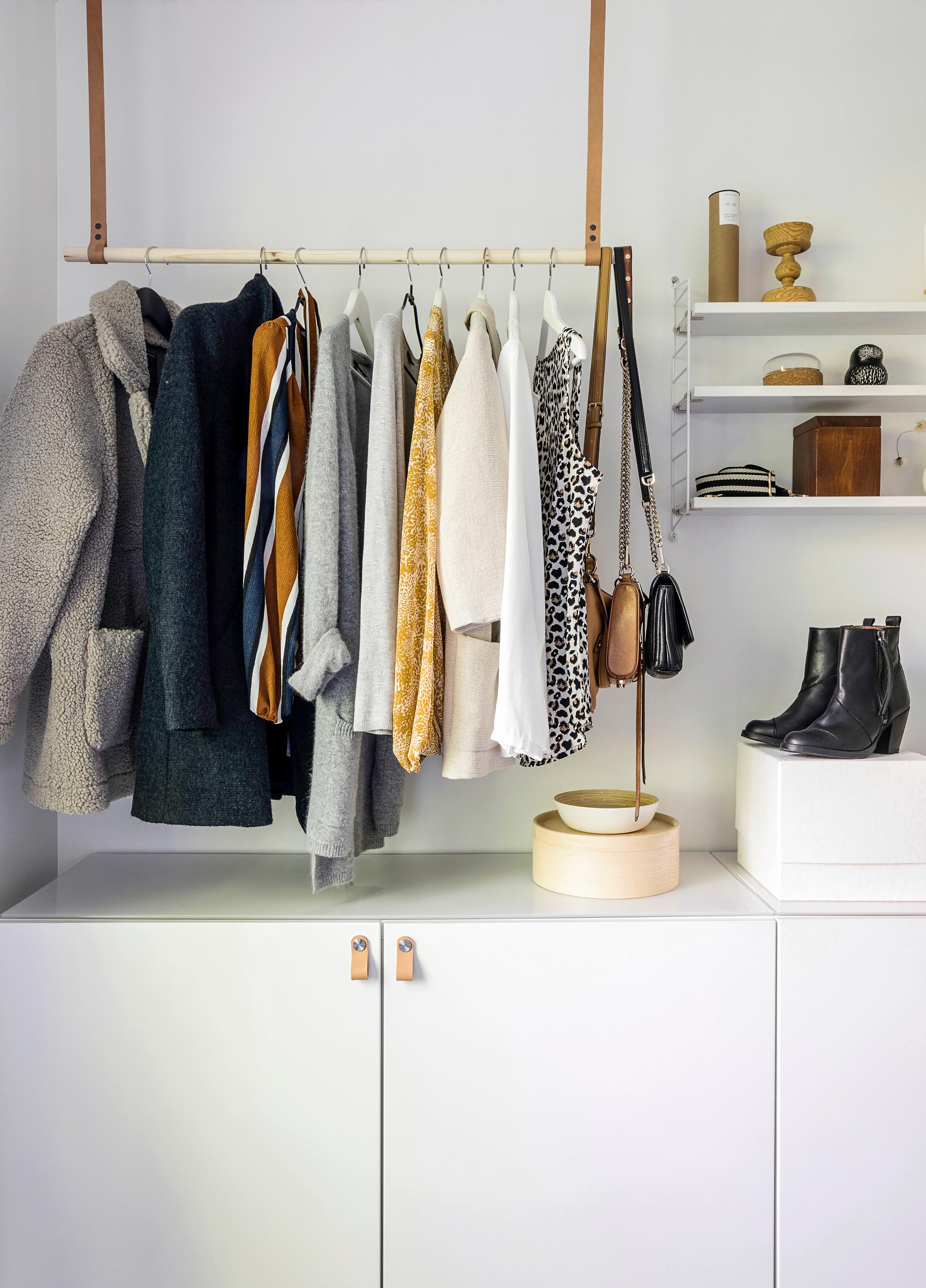 Hanging clothes rack in a walk-in closet