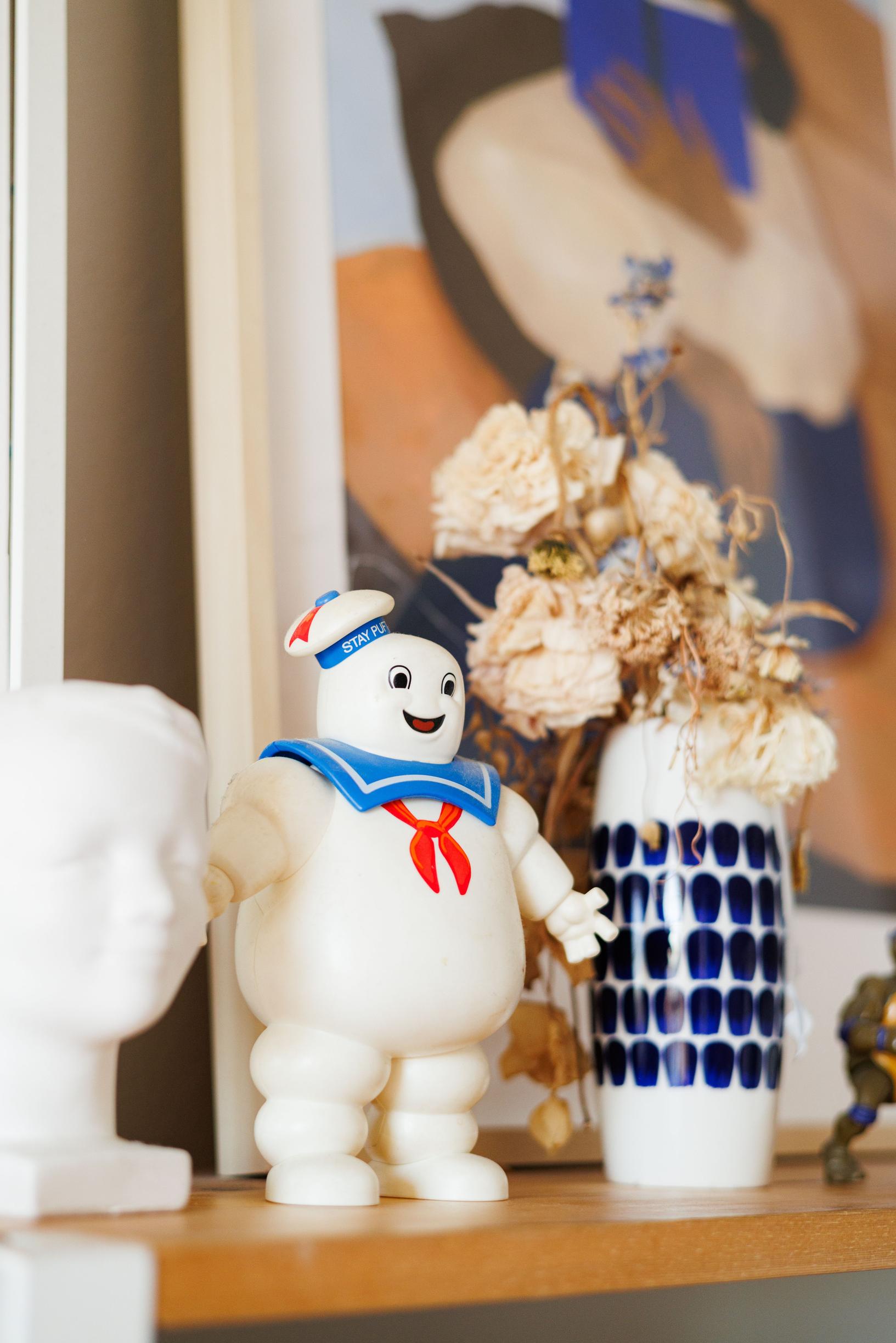 a Hymypoika statue and other items on a shelf