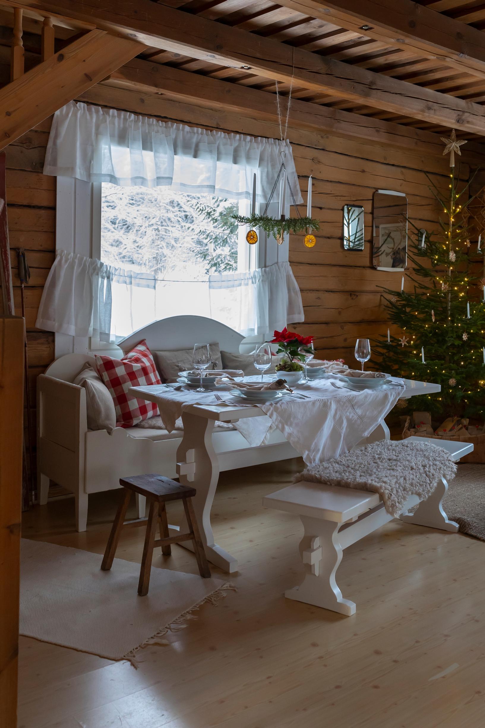 A wooden sofa in front of the window