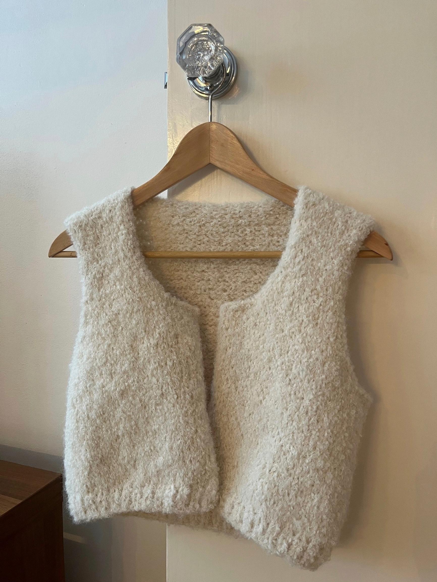 Fuzzy vest on a hanger