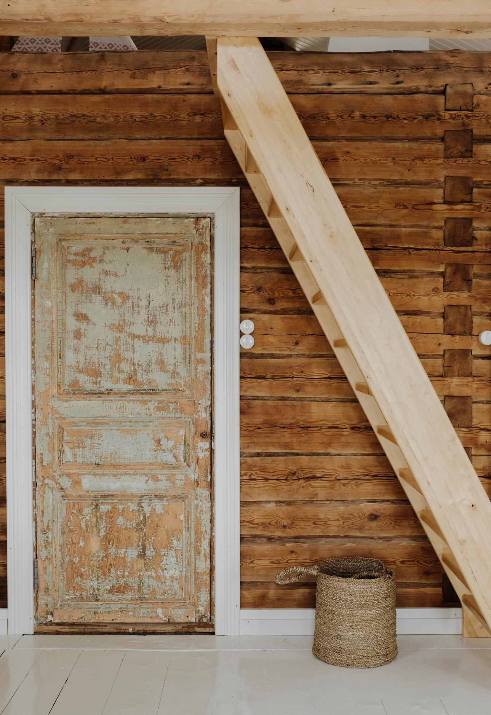 Next to the loft stairs are old doors with the oldest layer of paint exposed
